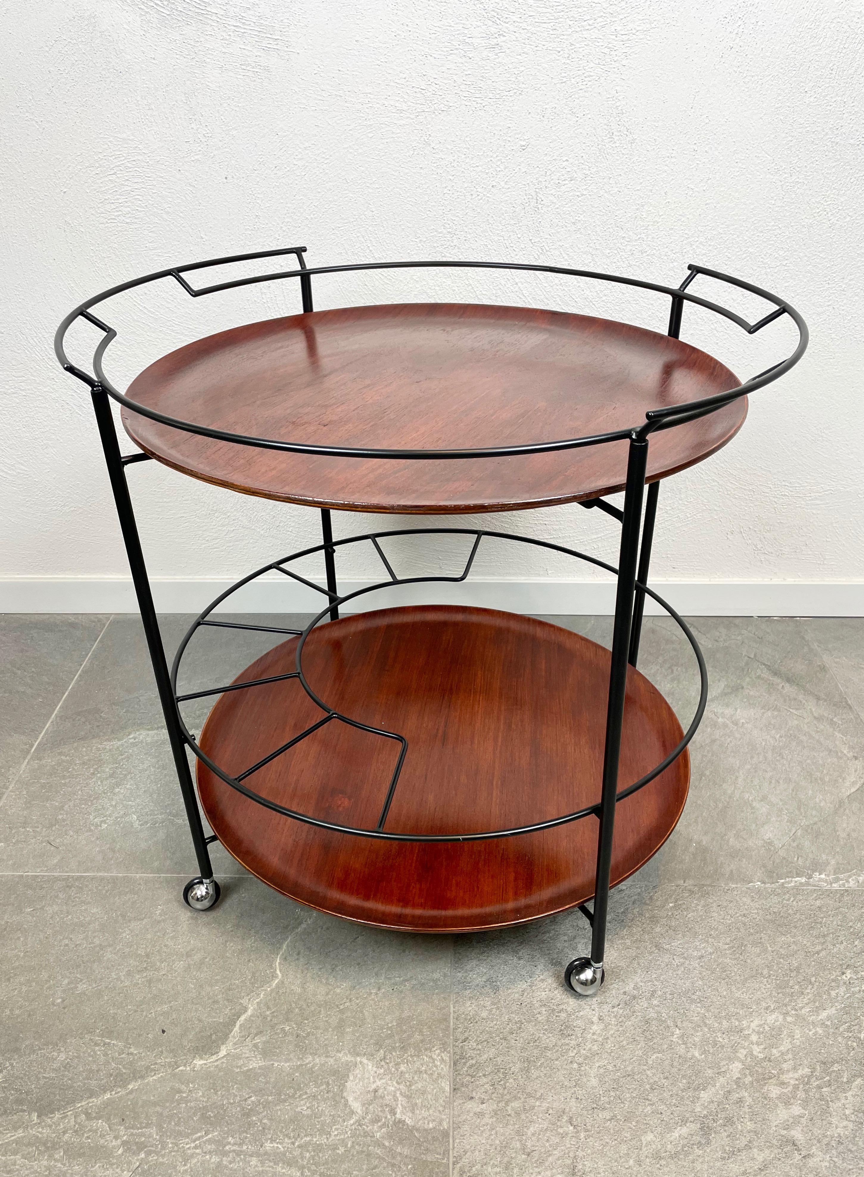 Serving cart tray composed of two removable teak shelves and metal structure painted black which also serves as bottle holder. Made in Italy in the 1960s.