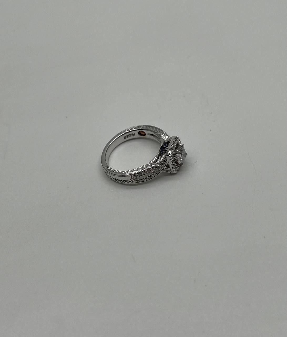 A refined Diamond Ring, featuring a central diamond set in a halo of smaller diamonds.
18K White Gold 
1.10 CT Center Round Diamond 
0.75 CTW Diamonds