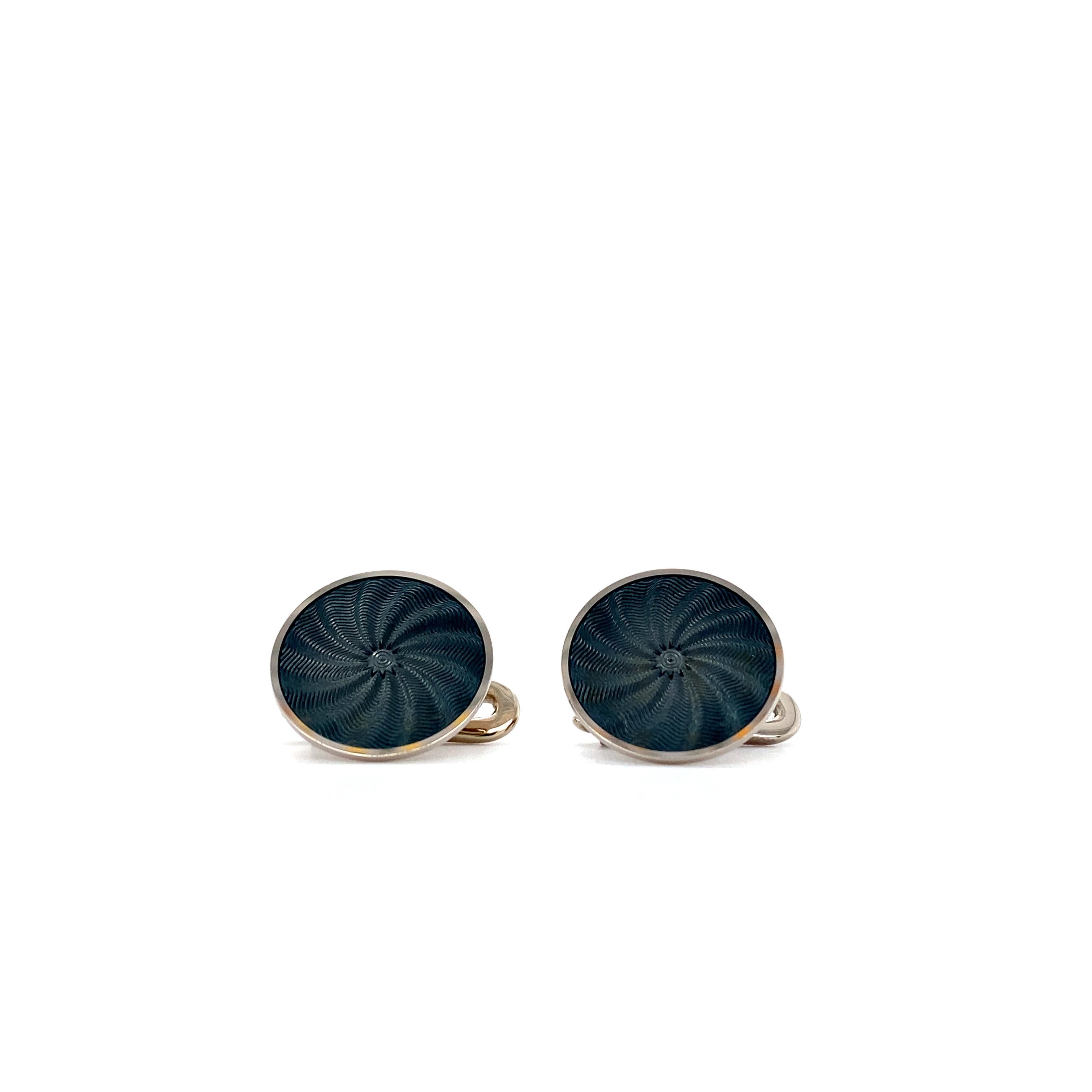 Victor Mayer round shirt studs, Globetrotter Collection, 18k white gold, dark turquoise vitreous enamel, windmill guilloche pattern, diameter app. 14.8 mm

About the creator Victor Mayer
Victor Mayer is internationally renowned for elegant timeless