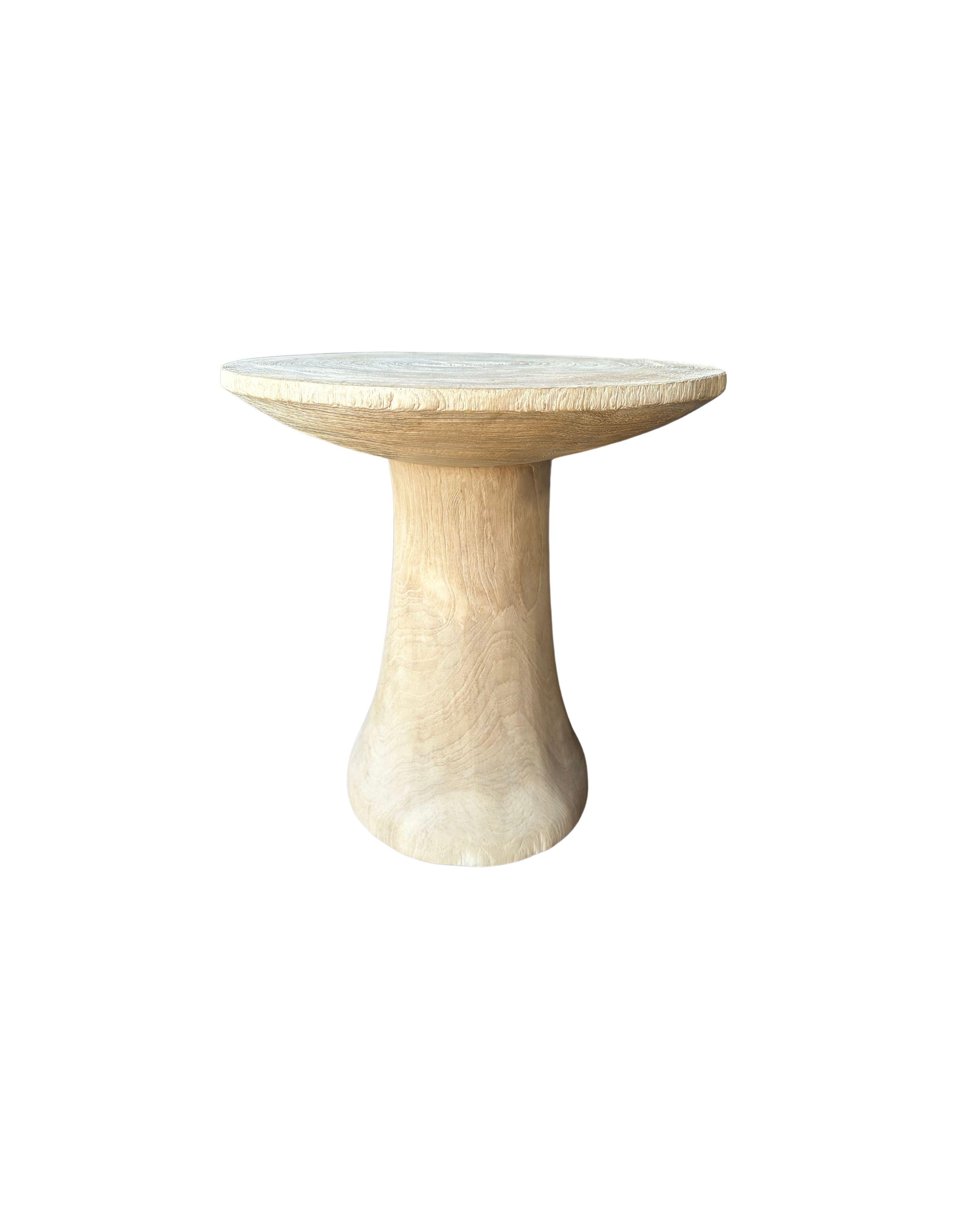 A wonderfully organic round side table. Its pigment was achieved through bleaching the wood. Its neutral pigment and subtle wood texture makes it perfect for any space. This table was crafted from mango wood and has a smooth texture. 

 