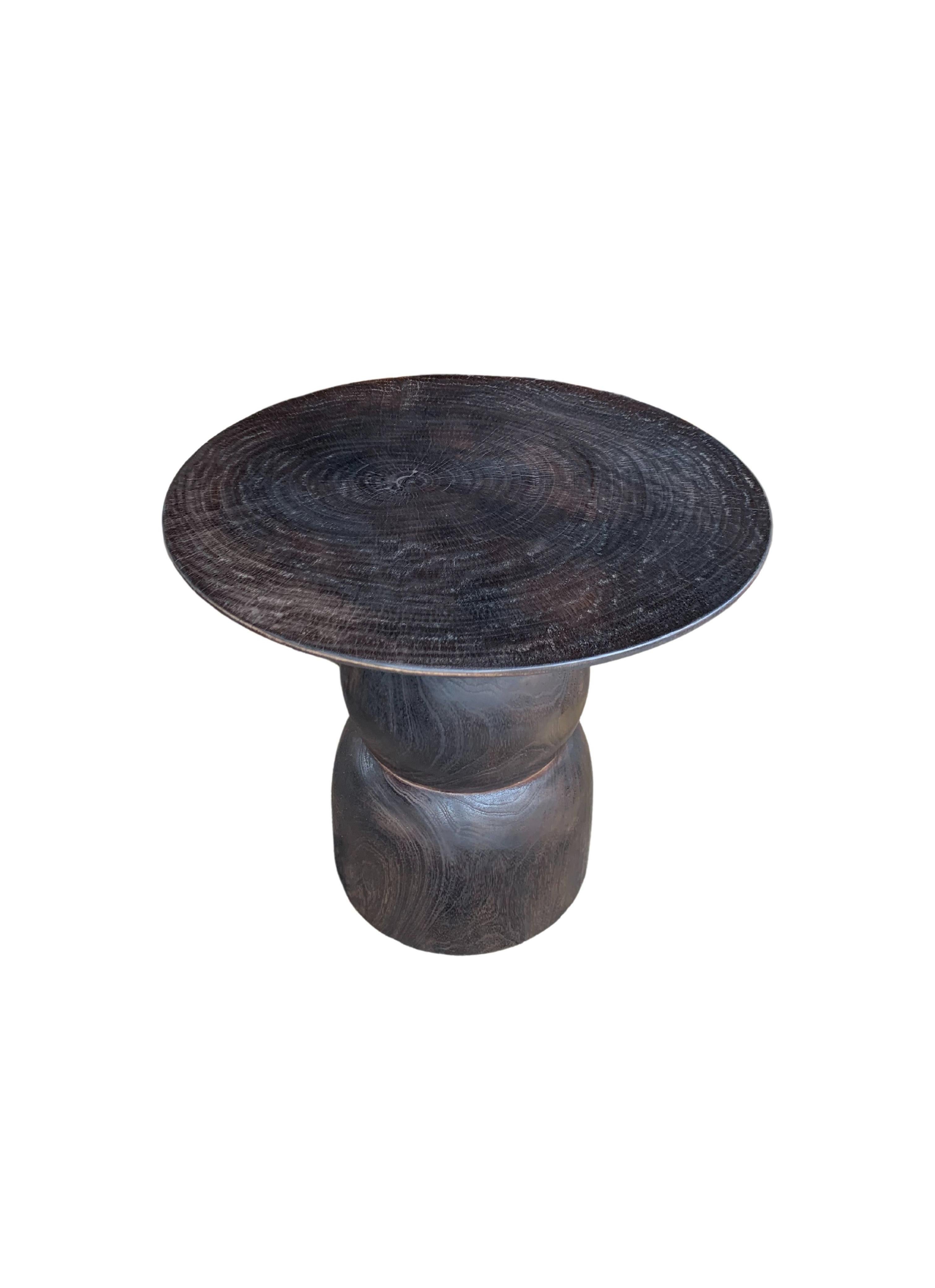 A wonderfully organic round side table. Its neutral pigment and subtle wood texture makes it perfect for any space. A uniquely sculptural and versatile piece, this table was crafted from mango wood and has a smooth texture. 

