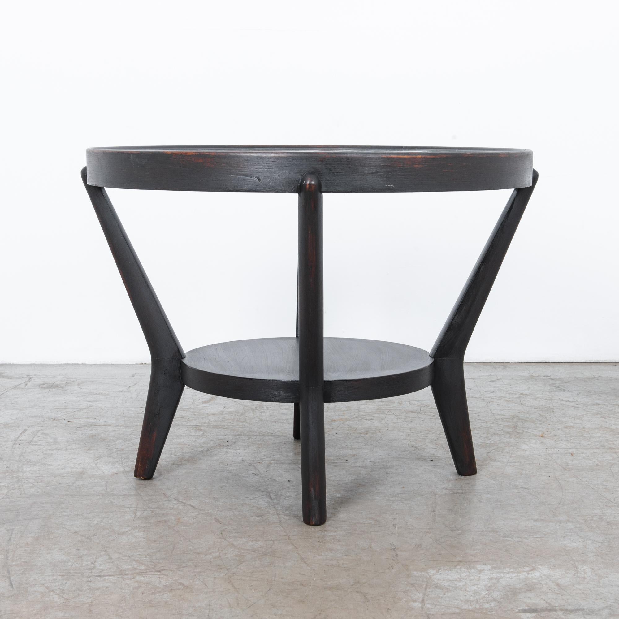 Dark finished oak frame, with clear glass top. This sleek design follows the pioneering style of Jindrich Halabala, designed by contemporaries Antonin Kropacek and Karel Kozelka. Concentric circle forms are held in place by dynamic rounded legs,