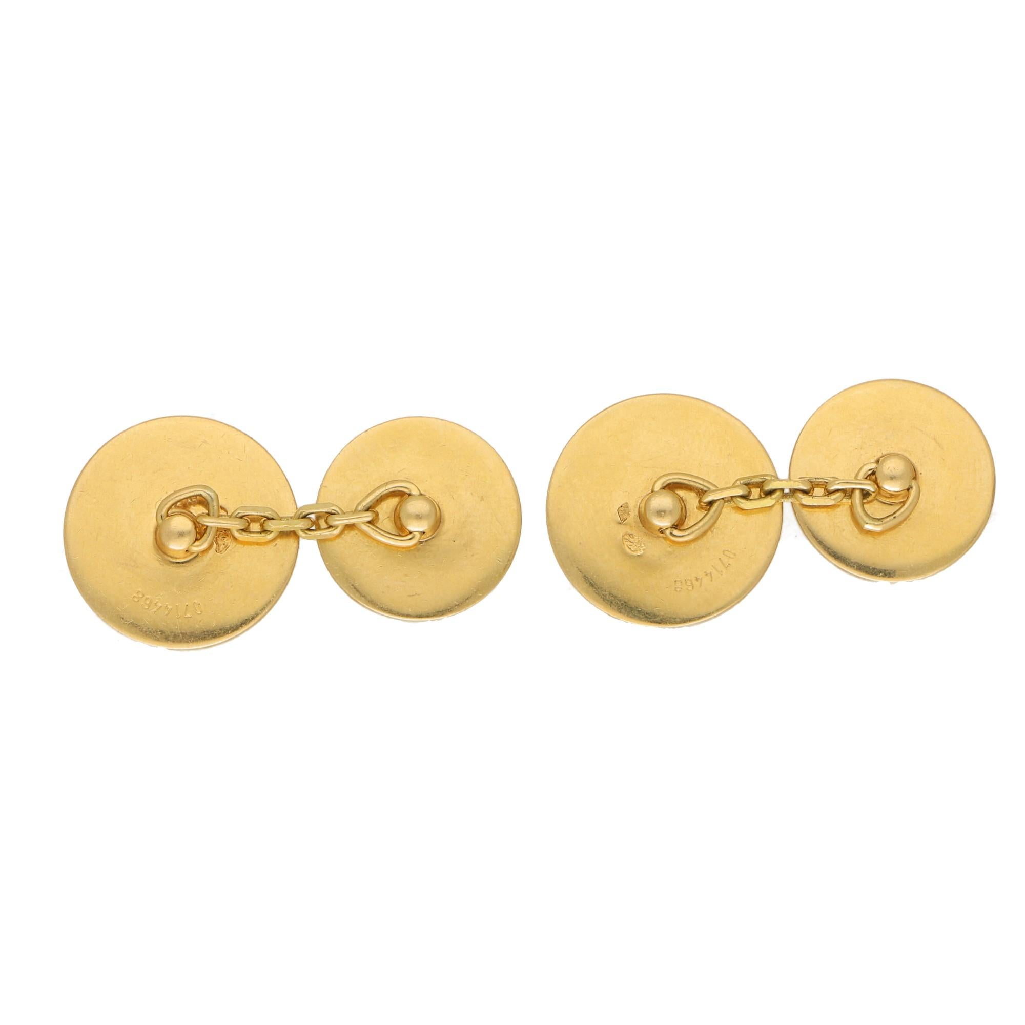 A lovely pair of signature Hermes button cufflinks set in solid 18k yellow gold. 

Each cufflink is composed of two round plaques and are each engraved with the Hermes logo. The round plaques are attached to each other by a secure chain fitting.