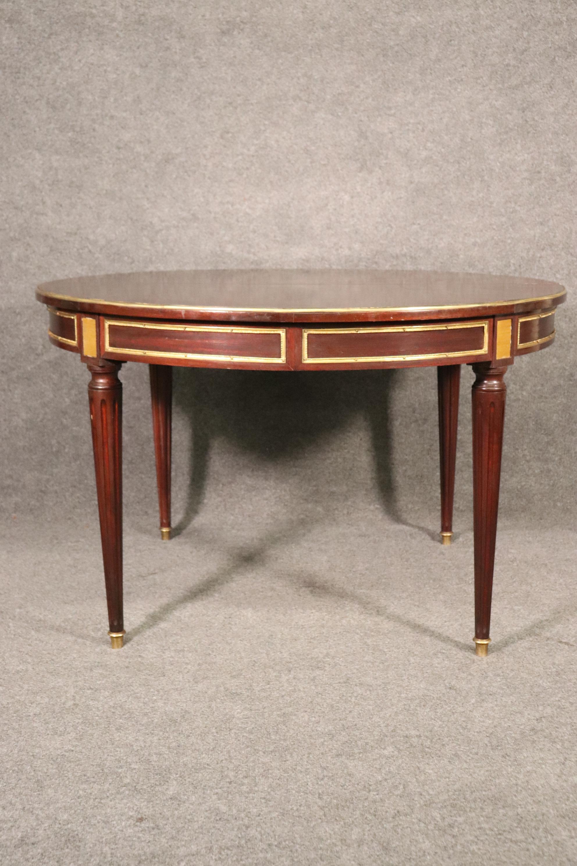 Mid-20th Century Round Signed Maison Jansen Brass Mounted Mahogany Louis XVI Dining Table w Leaf