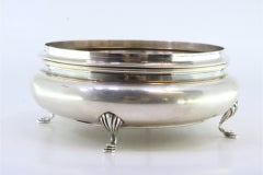 Round silver candy box w/ floral reliefs & 4 feet