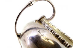 Round silver candy box w/ top reliefs, 2 applied handles & round base