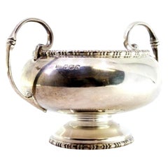 Round silver candy box w/ top reliefs, 2 applied handles & round base