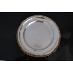 Piatto rotondo in metallo argentato firmato Ubner