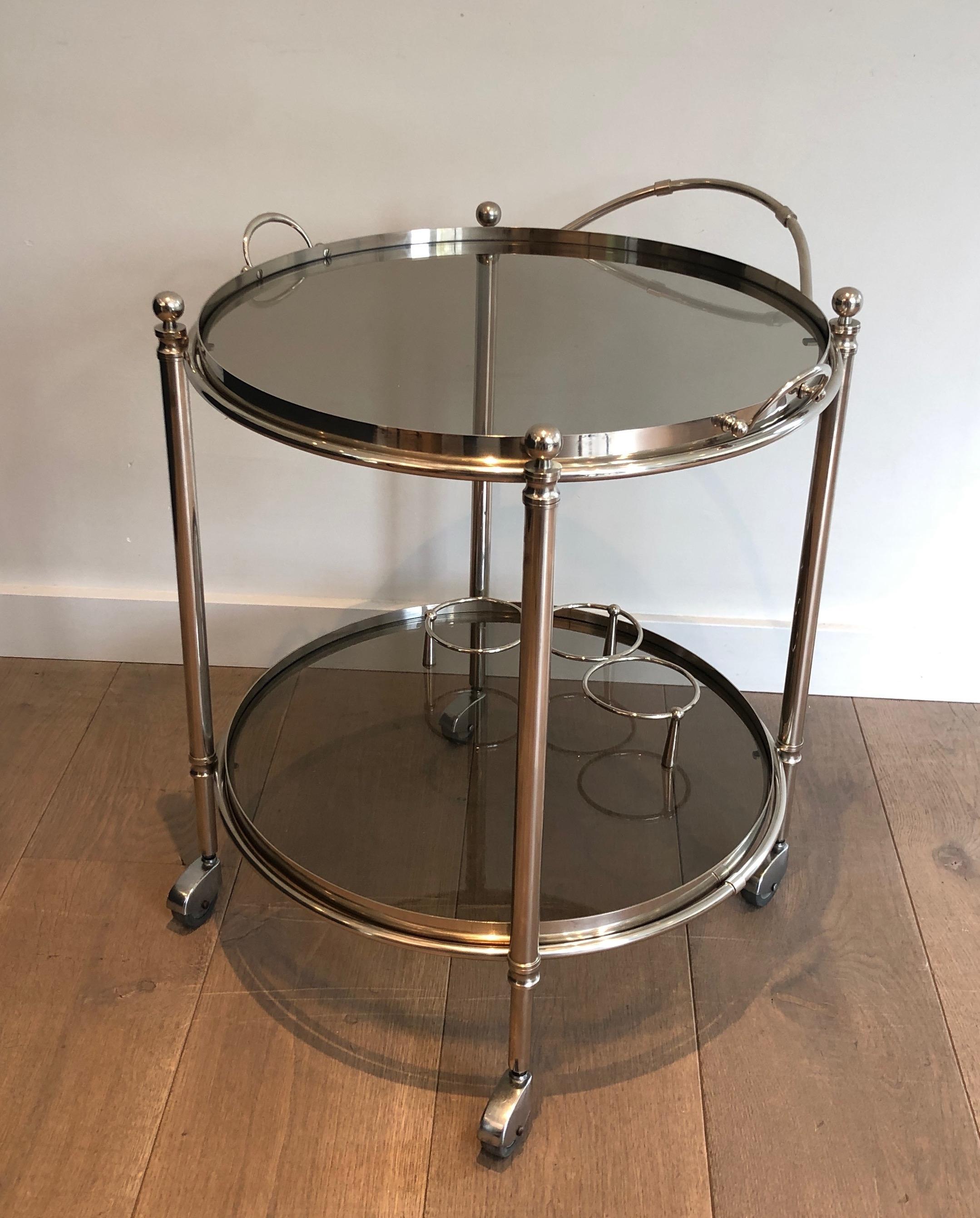 This nice and unusual round drinks trolley is made of chrome. The top tray of the bar cart is removable and can be used as a tray to display glasses, bottles, vaissels or other... This is a French work. Circa 1970