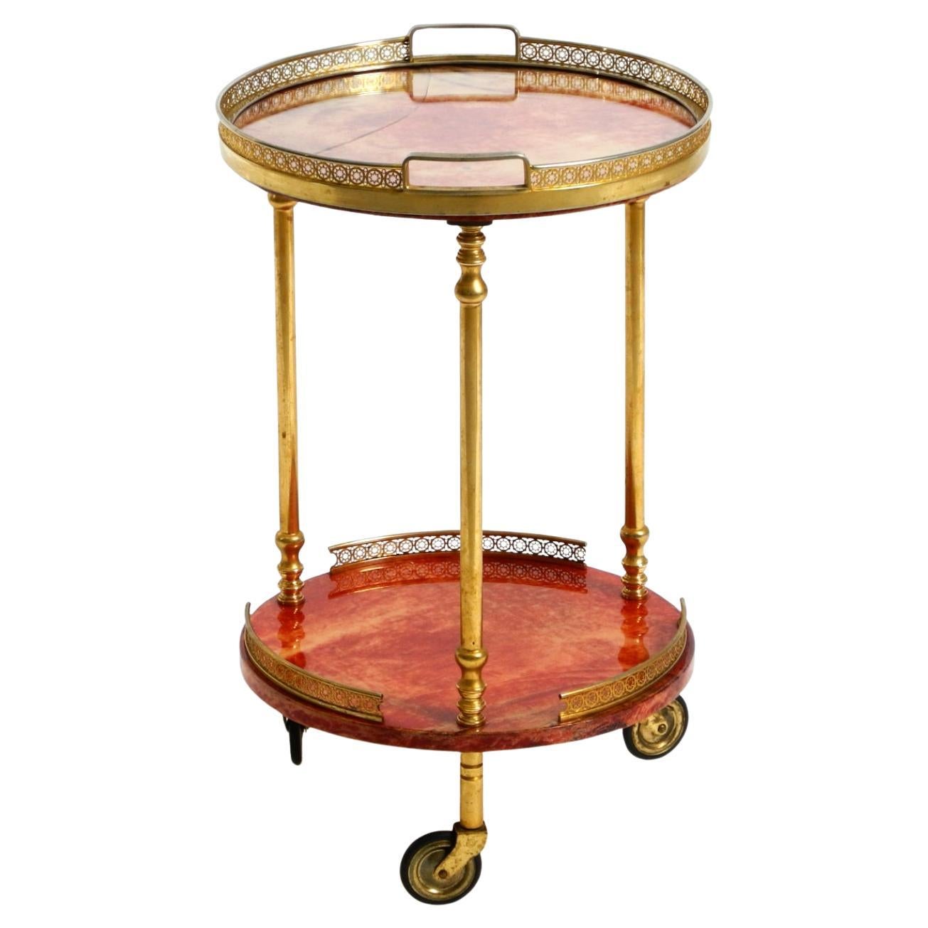 Round, small 1960s Aldo Tura serving or bar trolley in red goatskin leather