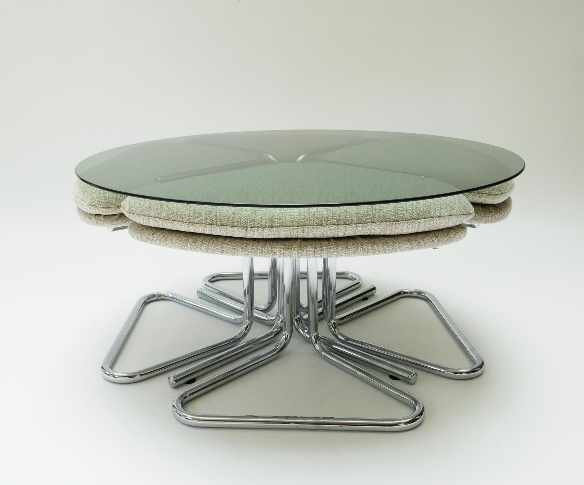 Round smoked glass and chrome coffee table with four nesting stools, 1970s.