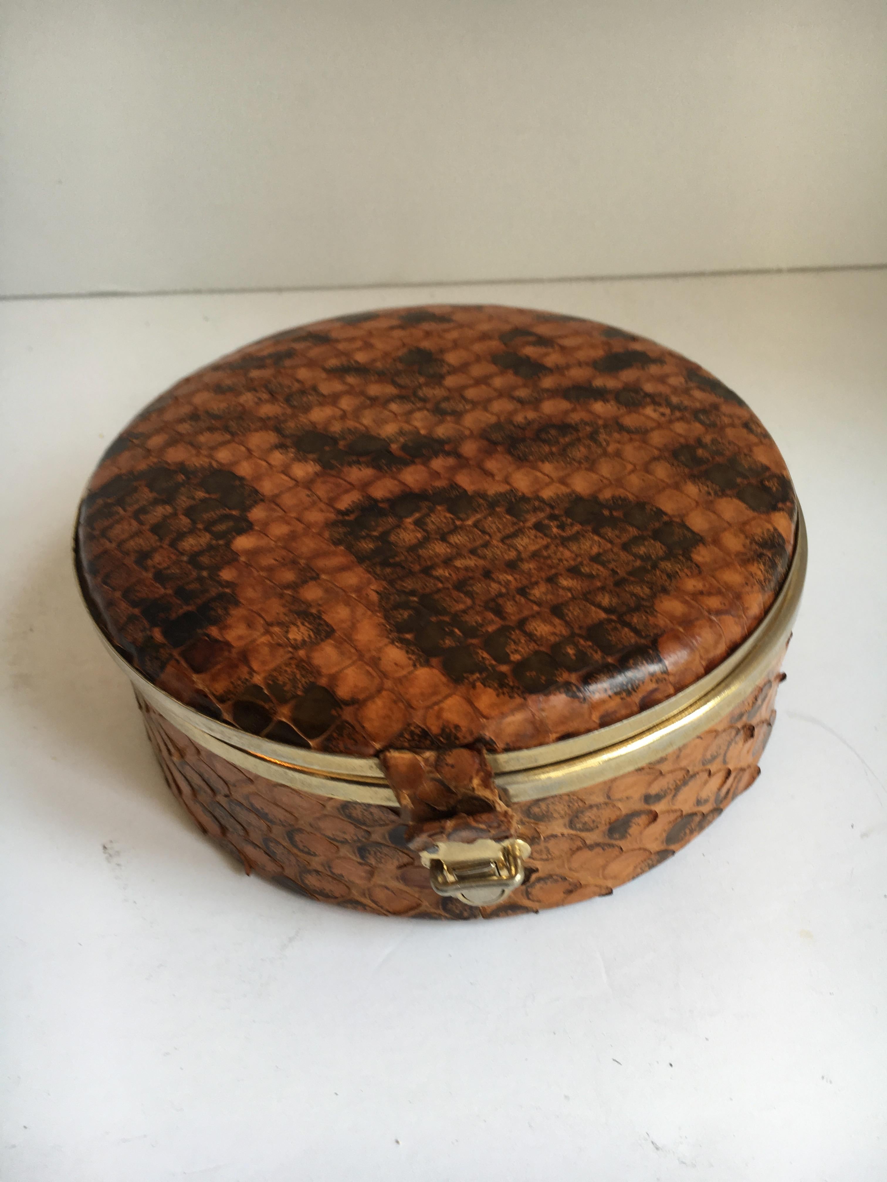 Round snakeskin box with brass detail and closure - a very handsome box of real snakeskin - well made and ready for any shelf or office space - store old letter, jewelry or 420 in this box - a lovely addition to any room with style, adding a