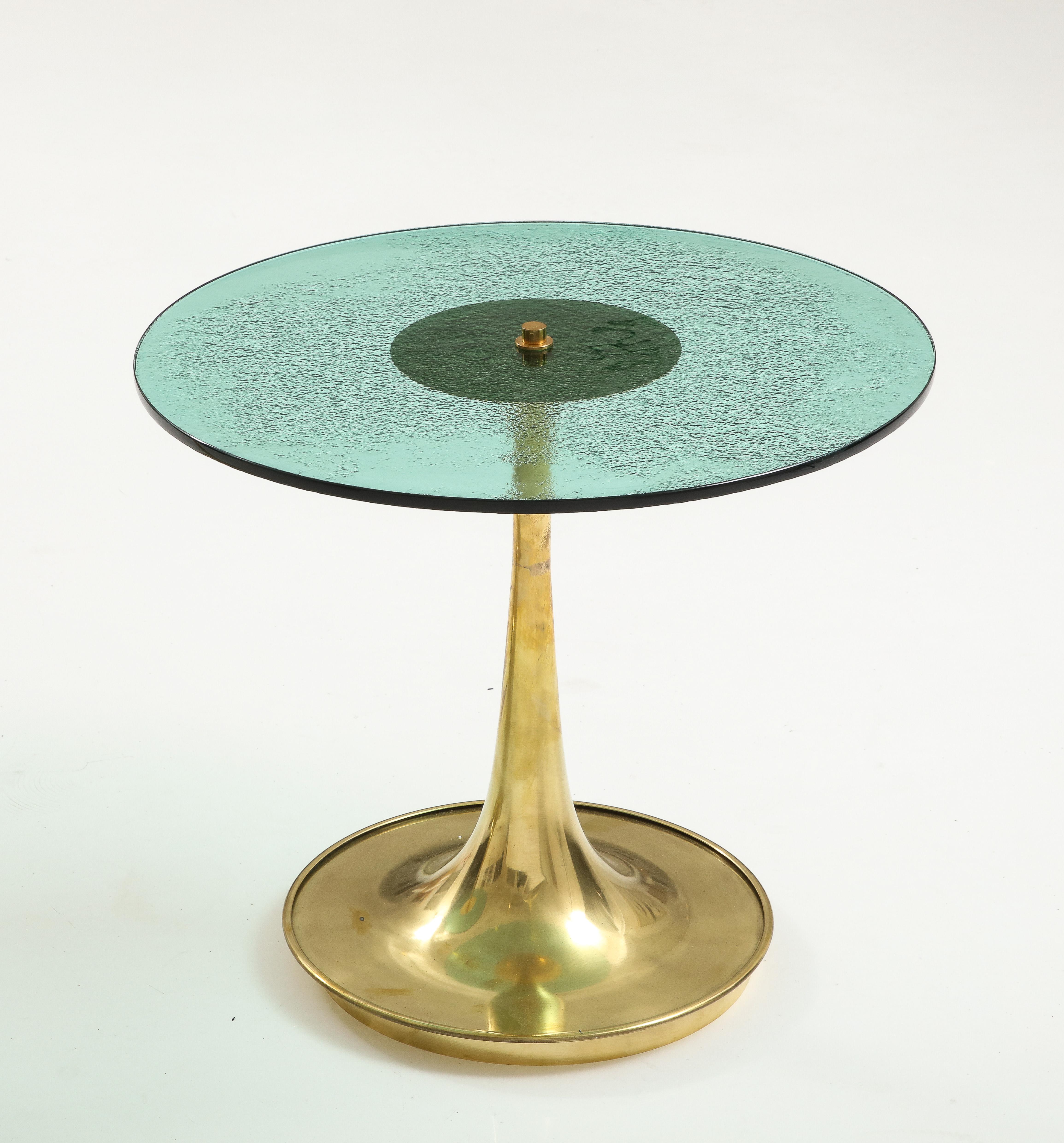Single Round Soft Green Murano Glass and Brass Martini or Side Table, Italy, 2023. Hand-casted 12 mm Soft Green colored Murano round glass top sits atop a hand-turned, trumpet-shaped brass base. The glass top is smooth and flat on one side and