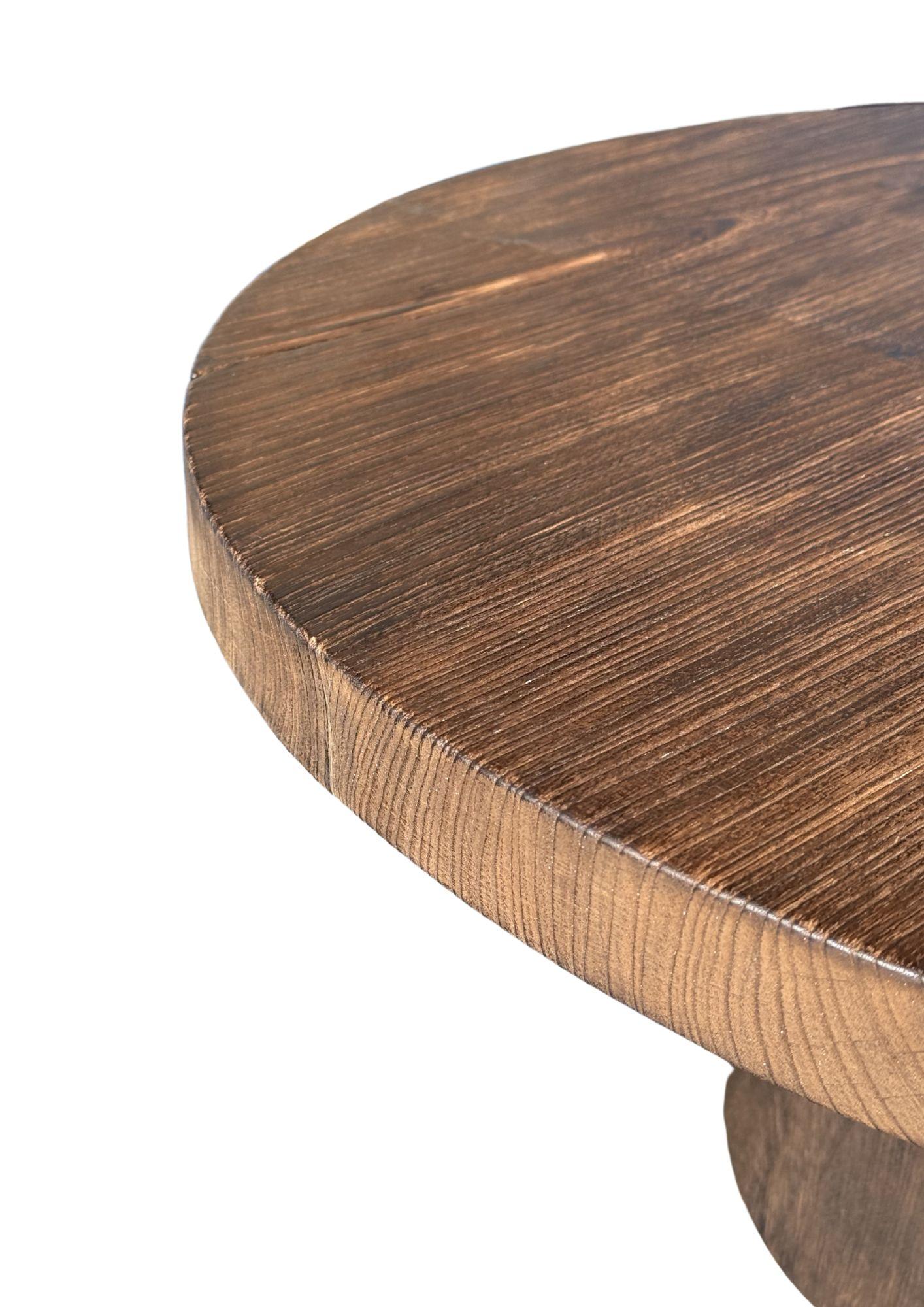 Introducing our exquisite organic Teak wood round sofa table, beautifully crafted with a striking burnt finish that enhances the natural beauty of the wood. This stunning piece showcases a rich array of textures and shades, highlighting the unique