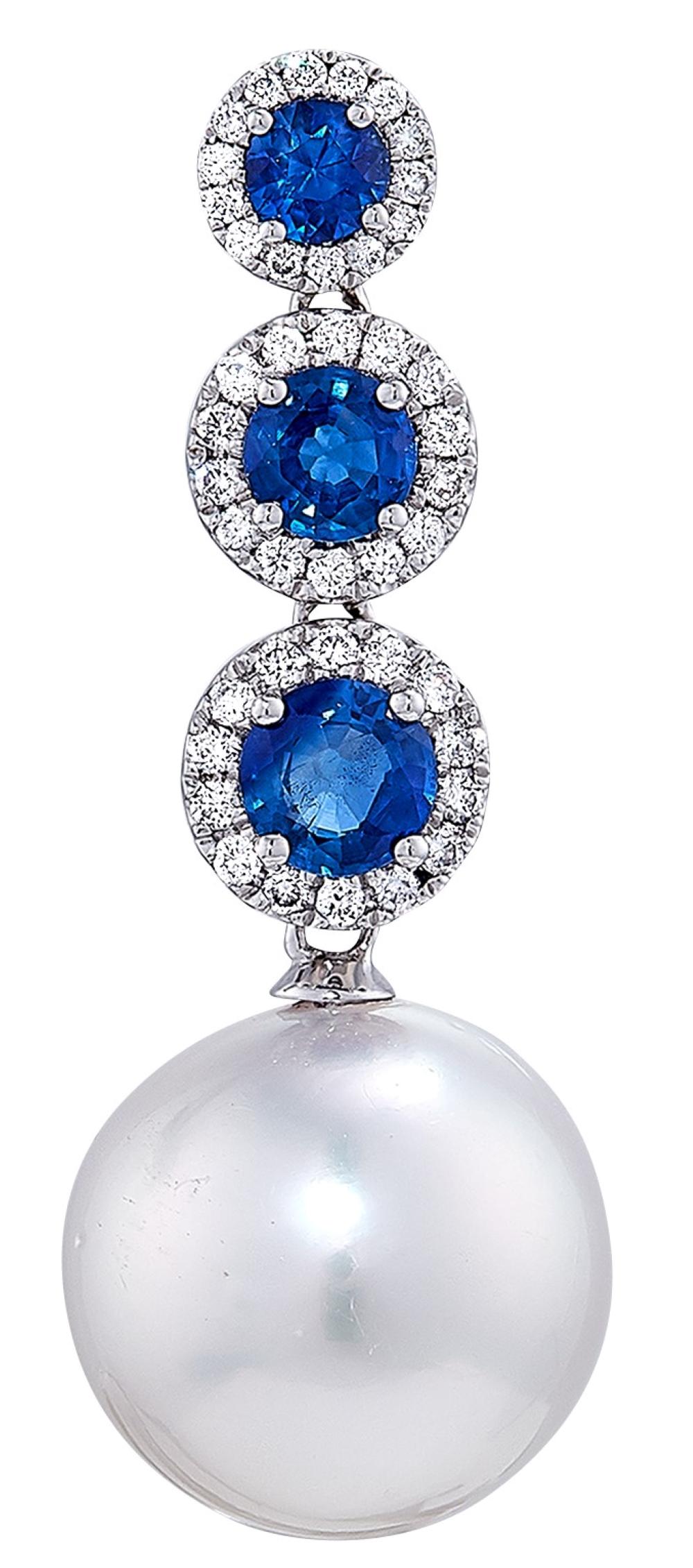 Exquisite drop style South Sea pearl, diamond, and sapphire earrings. Set to sway in the ear, these can't help but be noticed. 

Six round sapphires total 1.50 carats total weight. There are eighty-two round brilliant cut diamonds totaling .37