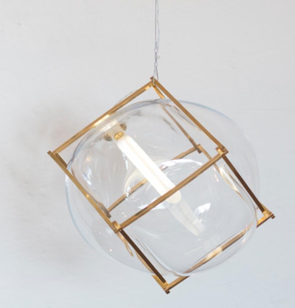 Round square captured bubble light by Studio Thier & van Daalen
Dimensions: W 30 x D 30 x H 30 cm
Materials: Brass, glass

When blowing soap bubbles in the air Iris & Ruben had the dream to capture these temporary beauties in a tendril frame.
