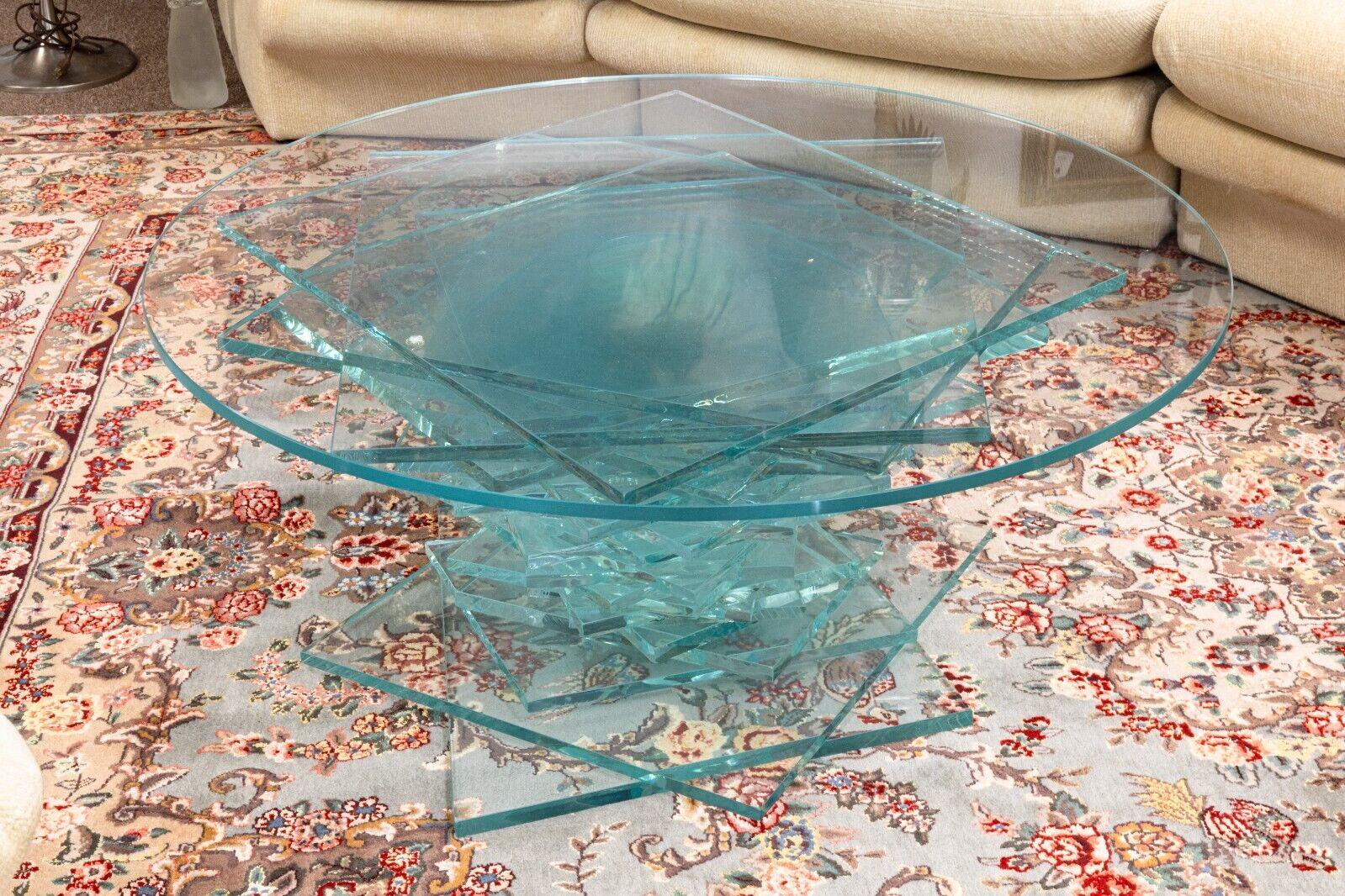 A round stacked helix contemporary modern glass coffee table. This is a stunning coffee table with a very unique helix design. This table is made completely of glass stacked together. There is a hallow cylinder down the center as pictured above.