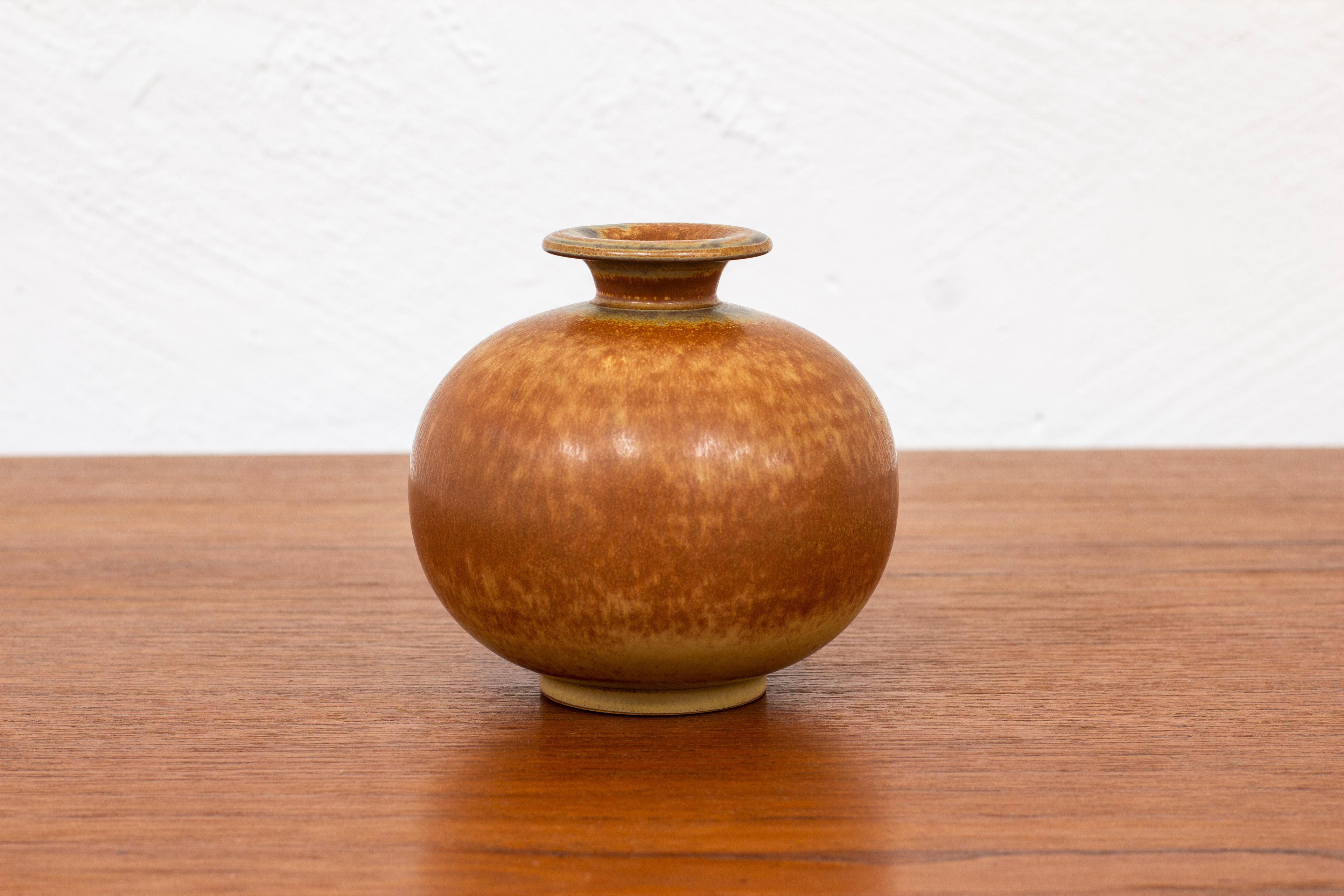 Stoneware vase designed by Gunnar Nylund. Hand made at Rörstrand in the 1940s. Glaze with burnt brown tones. Very good vintage condition with light wear and patina.

