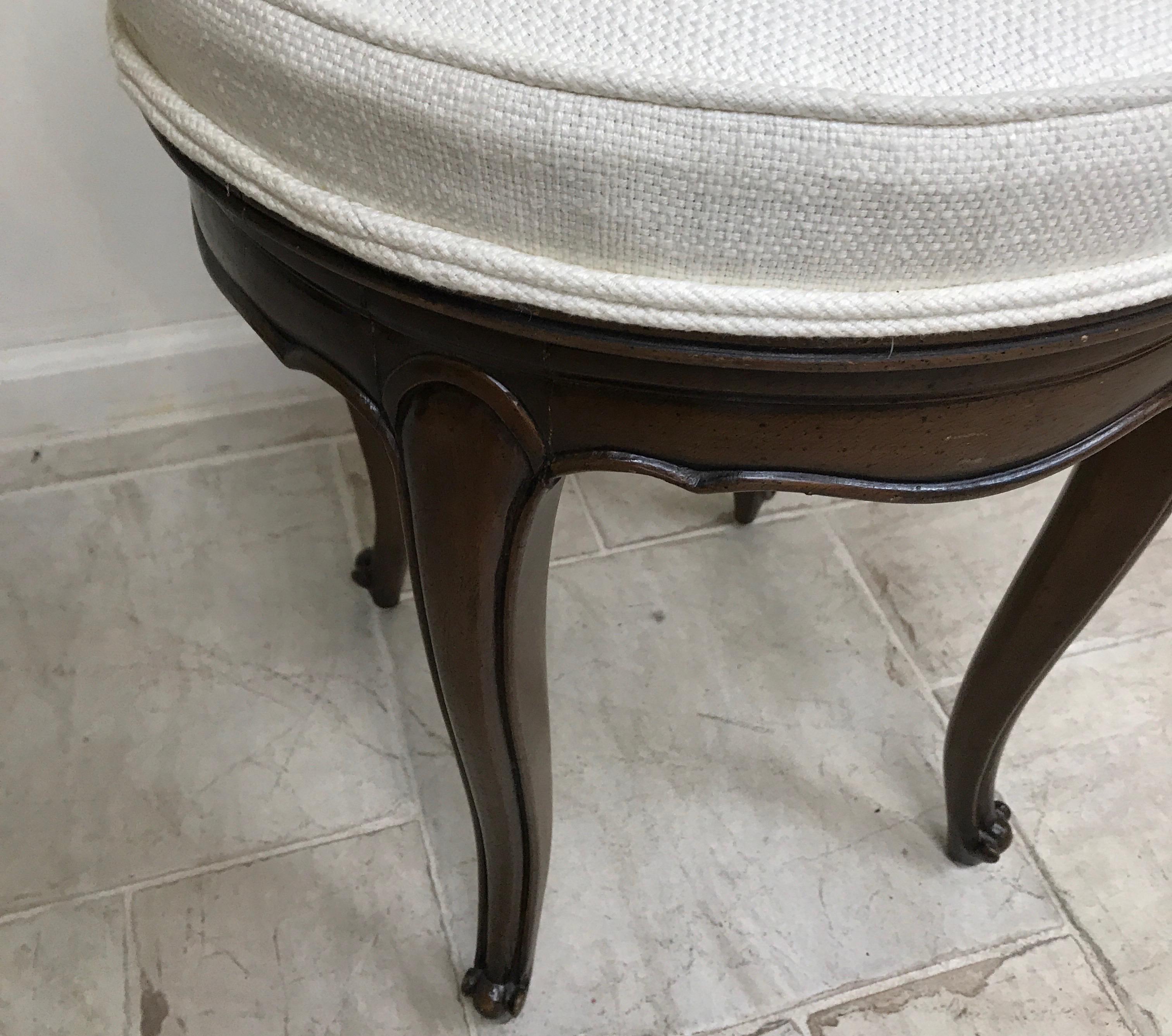 Dark walnut vanity stool with swivel seat.