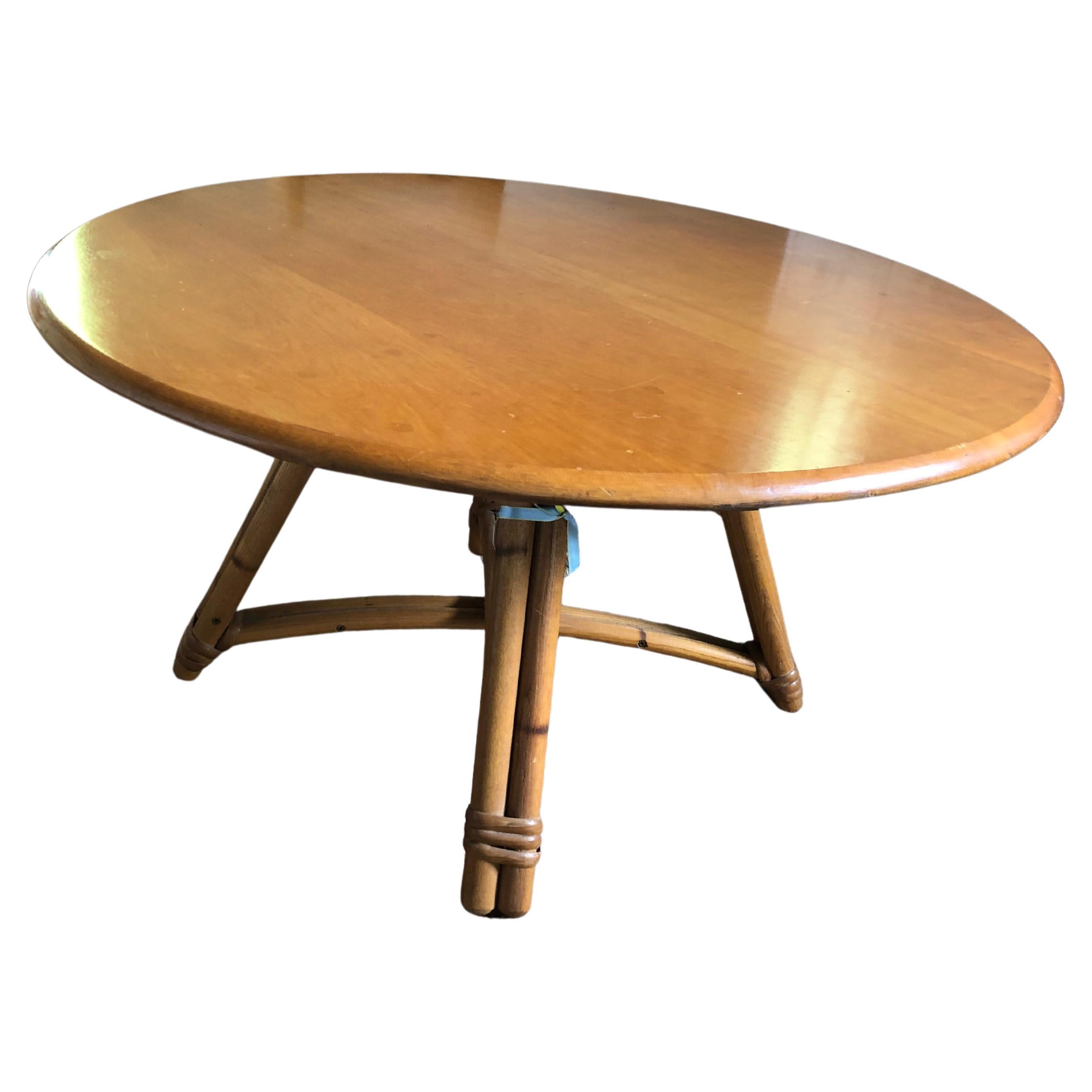 Handsome versatile Heywood Wakefield vintage round coffee table having solid oak swivel top with fabulous bamboo legs and stretcher.

(Matteo).