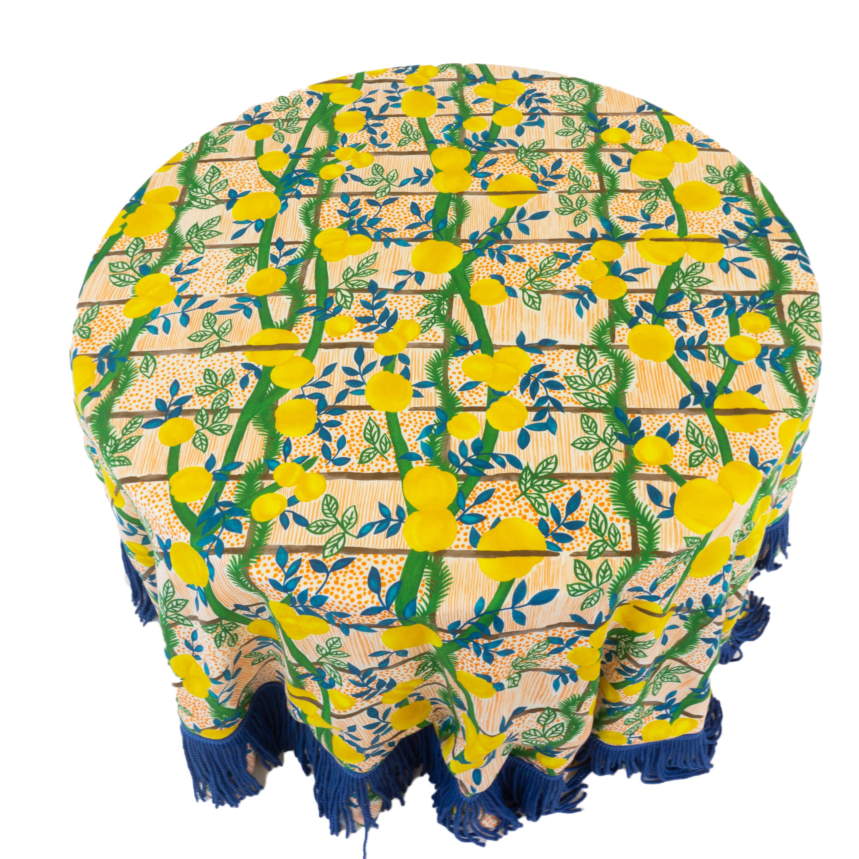 A hand sewn round table cloth in designer Jim Thompson fabric. The fabric features a cheery lemon garden pattern and is accented with a blue twisted fringe. Printed on 100% linen. Custom table cloths are available upon request. 

Table is sold