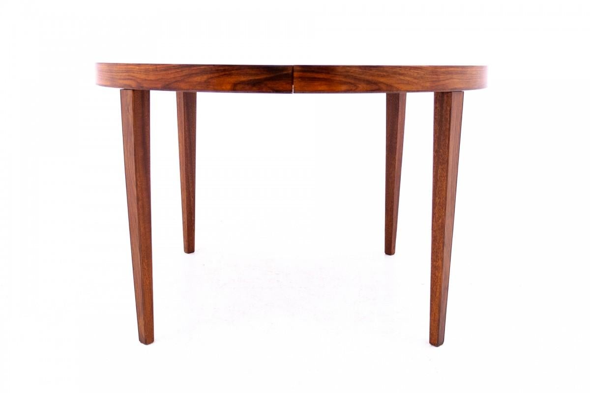 Round dining table, Denmark, 1960s.

The table is made in Denmark by Haslev Møbelsnedkeri, the underside of the top has an original label. The top is veneered with rosewood with a beautiful grain. The table has one insert, thanks to which we can