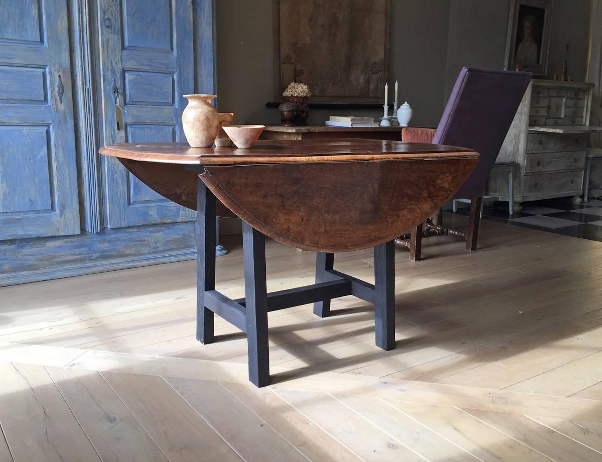 We made this drop-leaf table from a English 18th century elm top and remilled old French oak. The top has a beautiful grain and goes well with the charcoaled supports. The top has its original hinges and the supports are traditionally constructed.