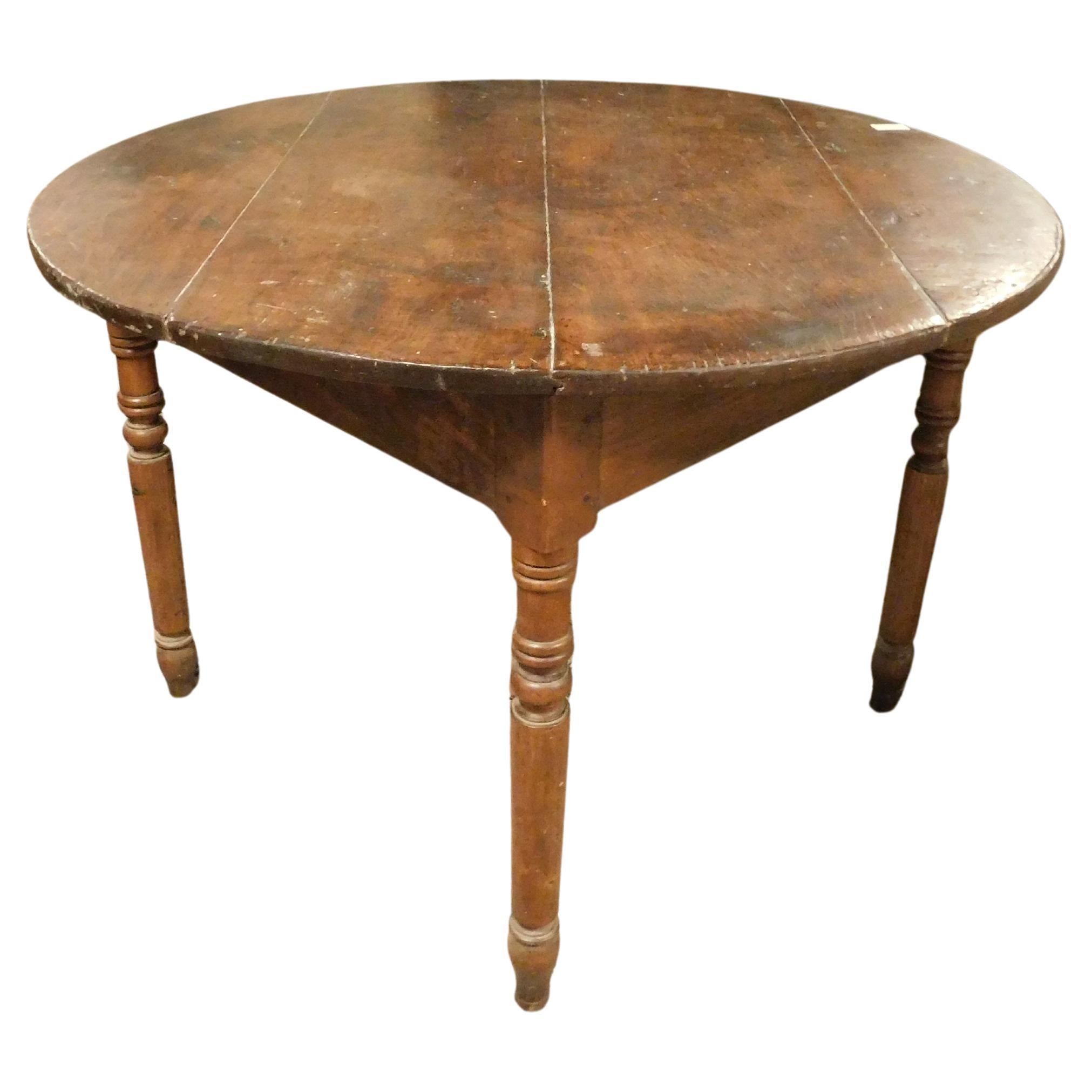 Round table in walnut and beech wood, carved legs, Italy For Sale