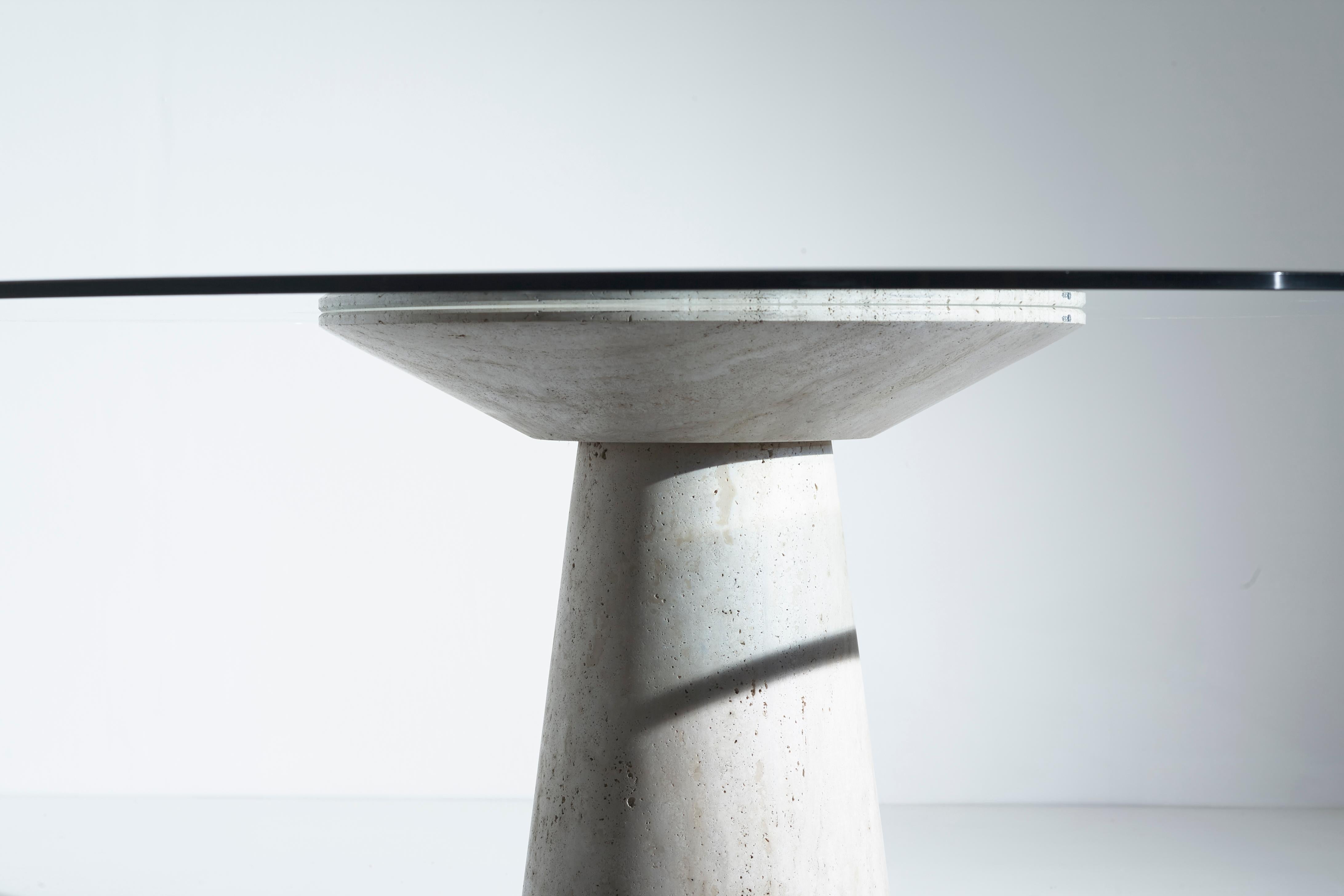 Italian Round Table with a Travertine Base and a Glass Top by Angelo Mangiarotti, 1970s