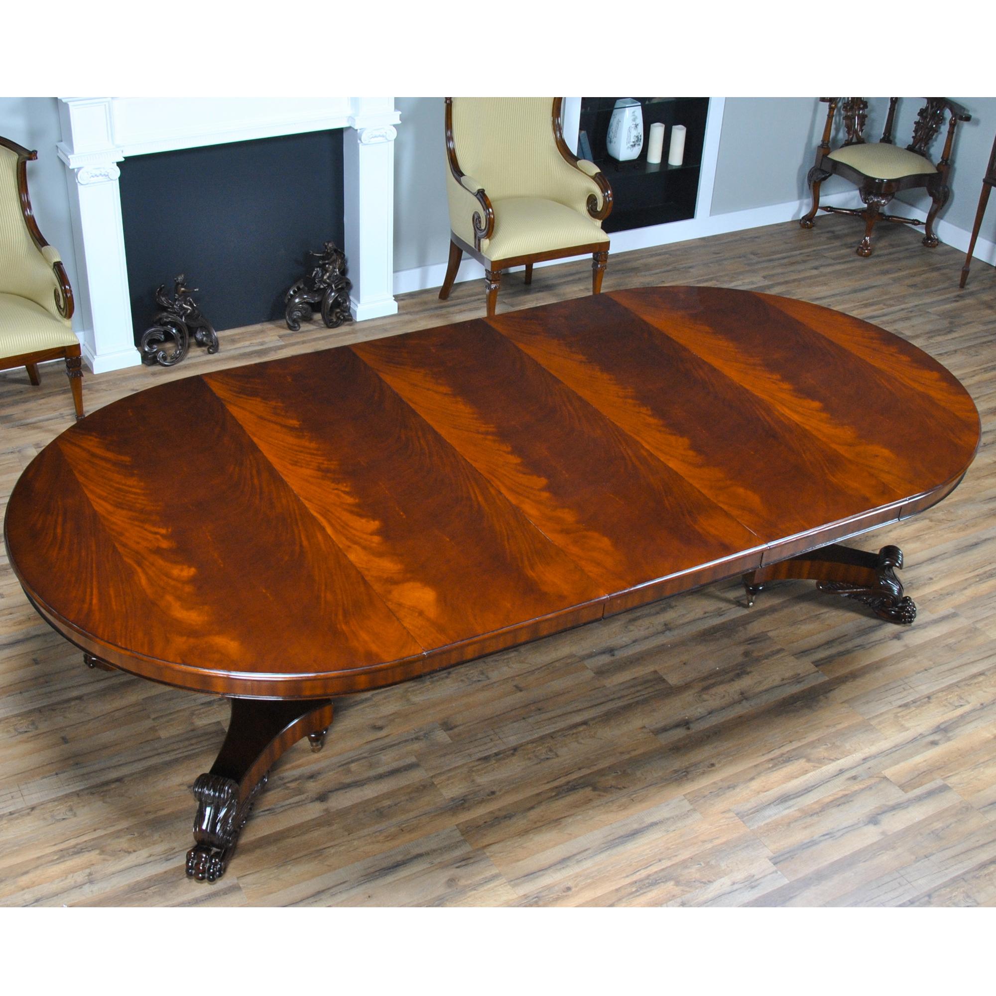 The Round Table with Empire Bases 60-115 inch is a high quality 60 inch round table when closed. The field of the table top being produced from the finest figural mahogany veneers and surrounded with a bull nose shaped molding. Three leaves can be