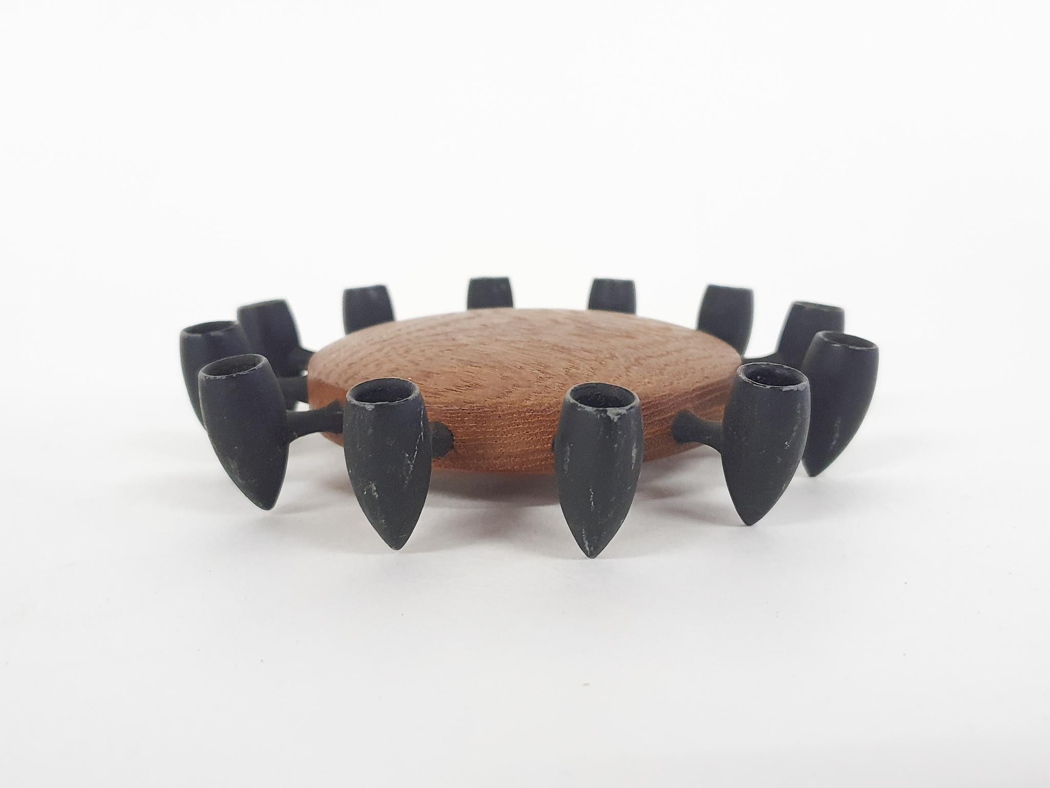 A nice candleholder by Danish manufacturer Digsmed, famous for their teak herb wheel. Digsmed was a manufacturer of many functional teak object in the Danish midcentury. This candleholder can hold 12 candles. Original and marked by maker.
      