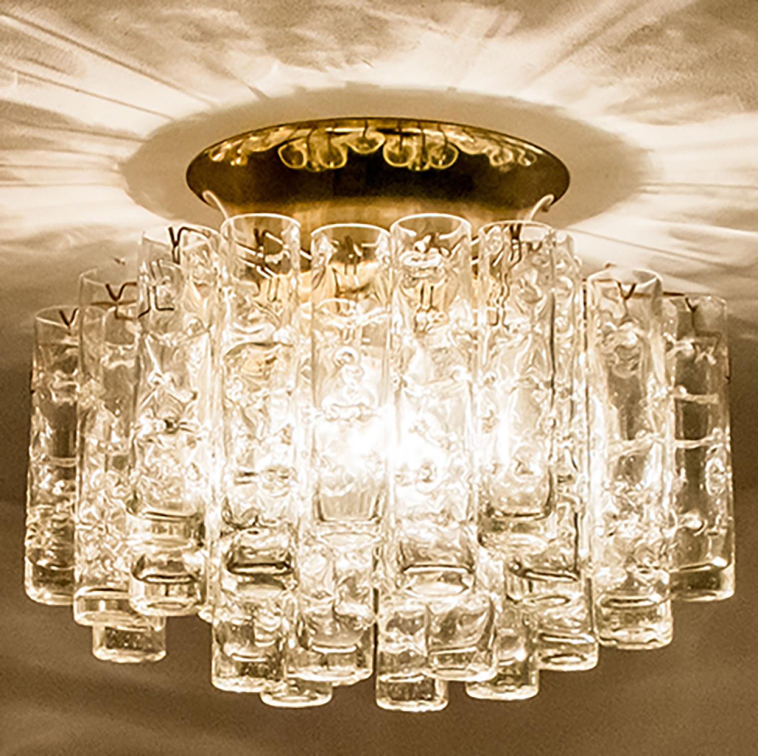 Star-shaped glass flush mount, manufactured by Doria Leuchten Germany in circa 1960.

This handmade light consists of a brass base with an array of high/end textured round tube-shaped art glass rods. Due the combination of materials, opal and clear