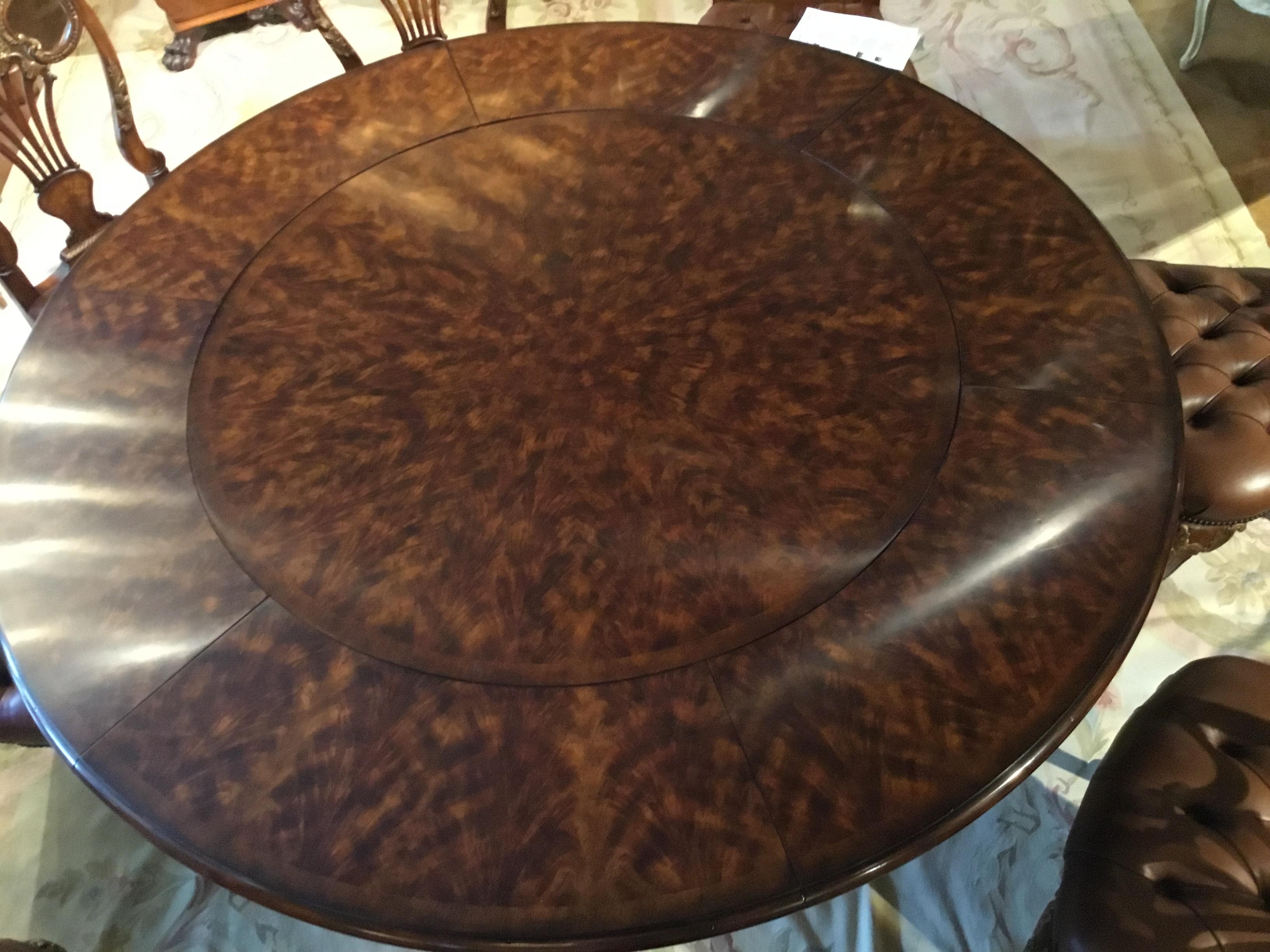 Beautifully matched flame mahogany veneers. Circular top and curved outer
Leaves. Raised on turned supports with contoured splayed legs and brass
Casters. 48” D without leaves and 74 diameter with leaves.