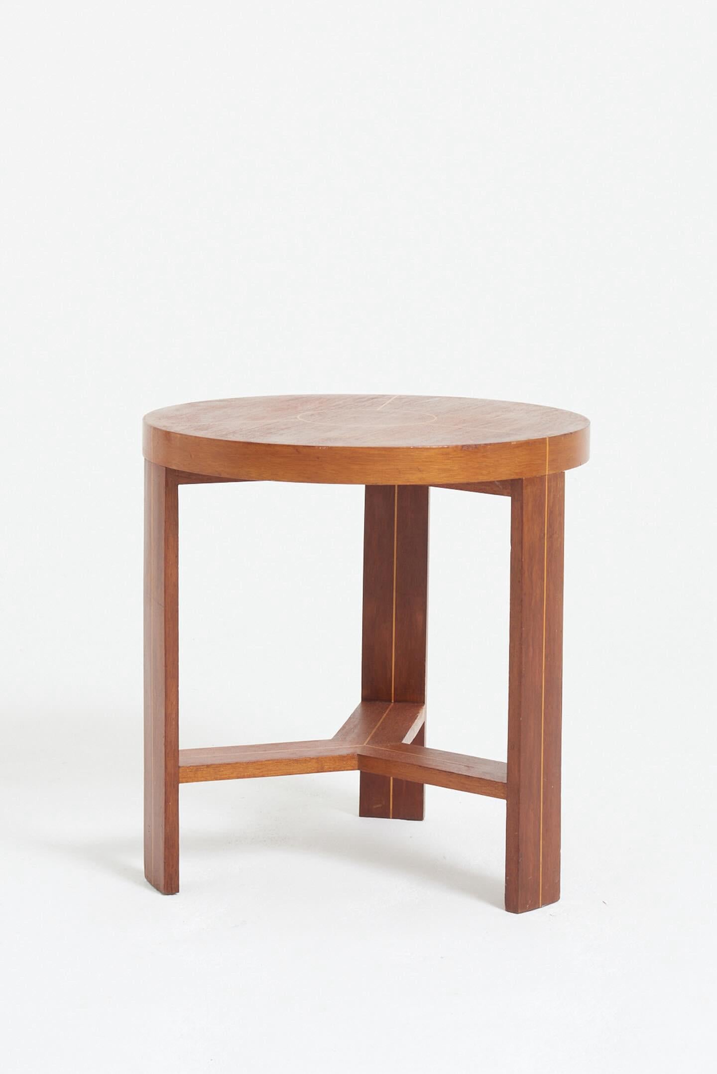 1950's English  round three legged side table.
Decorative thin stripe on legs, stretcher and top.
Triangular shaped stretcher.
Inlaid mahogany.
