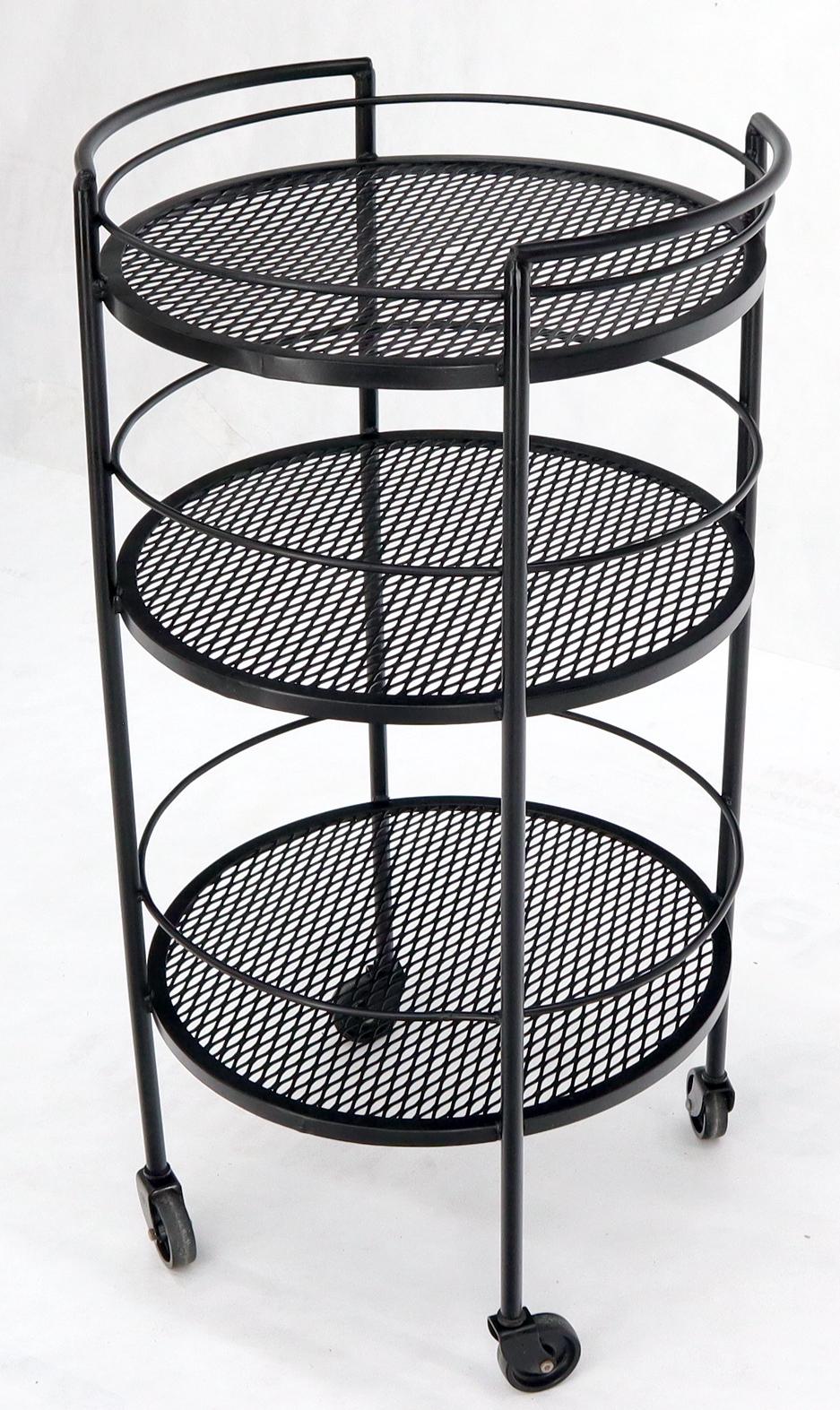 Mid-Century Modern round perforated metal cylinder shape serving cart on wheels.