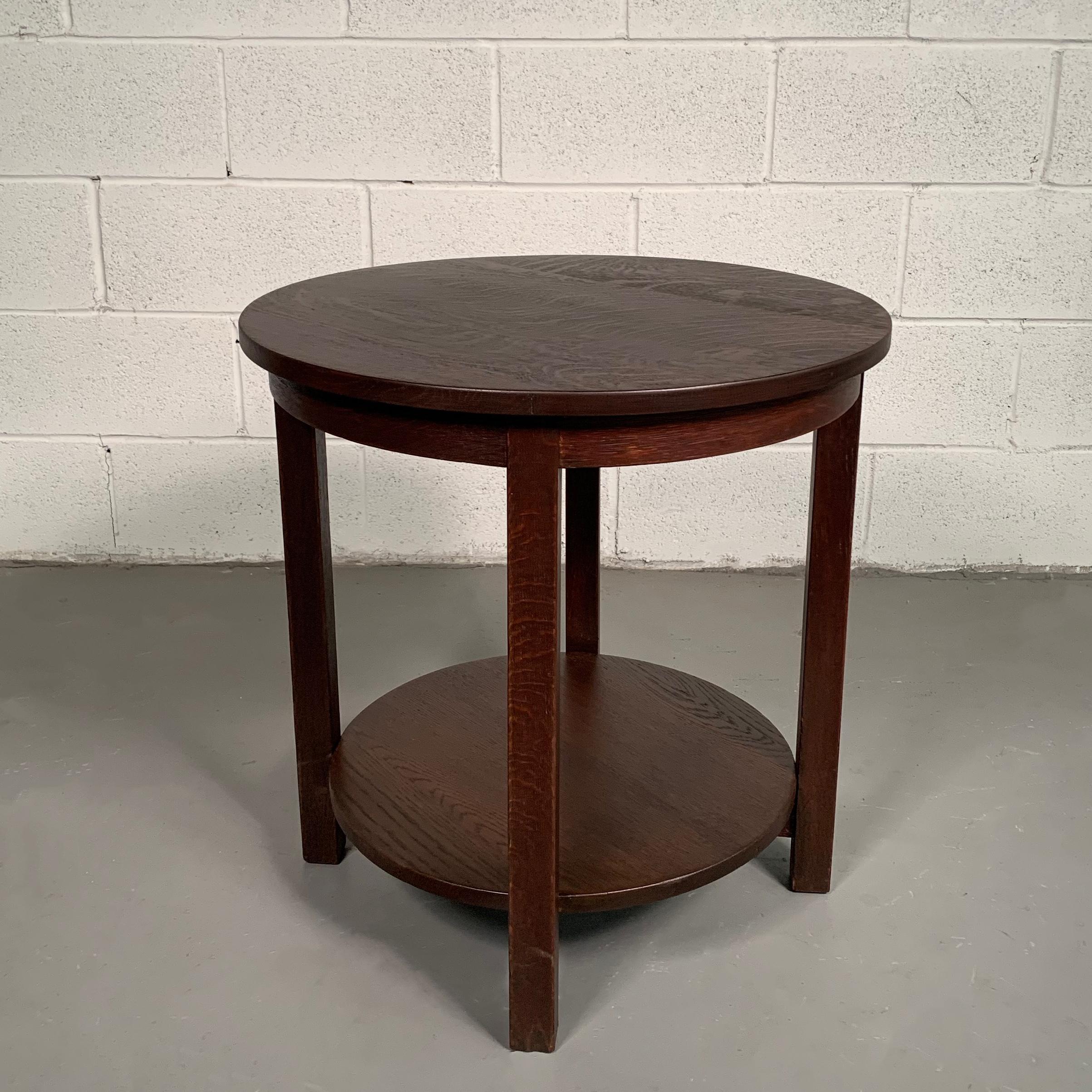 Early 20th century, craftsman, round, tiered, quarter sawn oak, side or center table by Stickley features a bottom level at 5.5 inches height. The table retains a partial paper Stickley label.