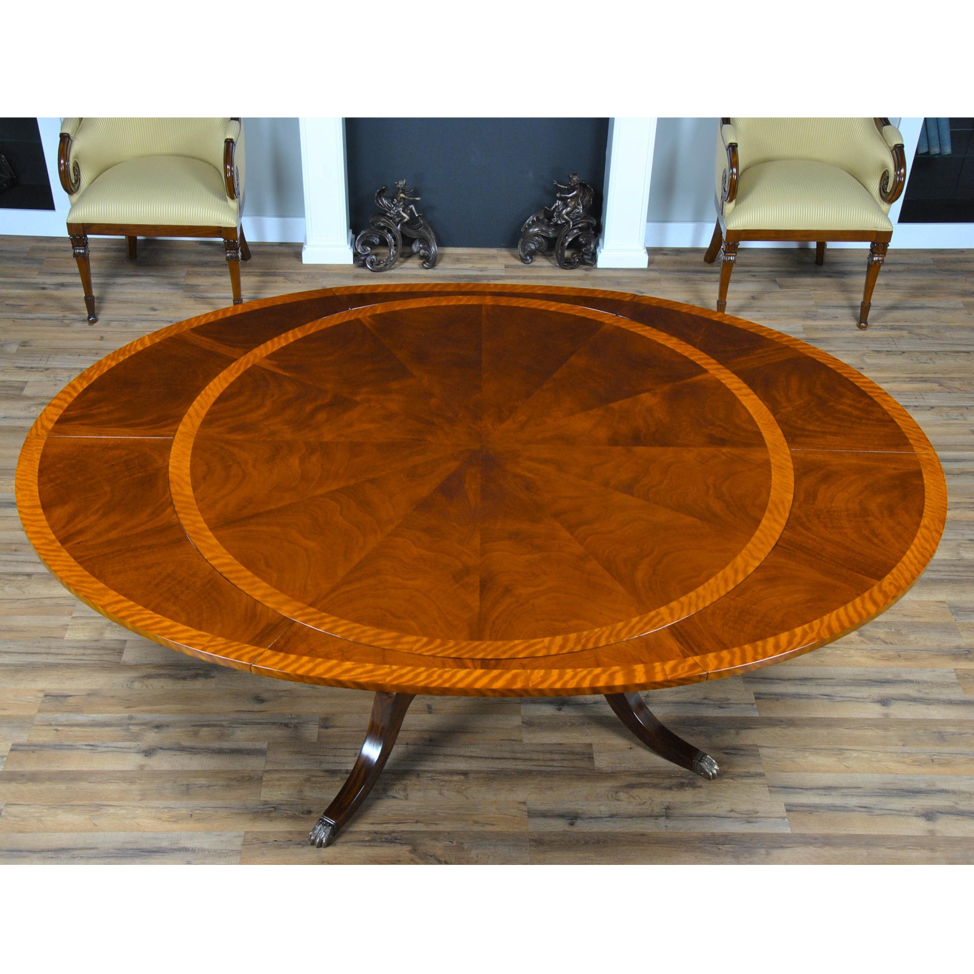 A sixty inch Round to Oval Perimeter Table is produced with a high quality figured mahogany field and satinwood banding makes for a bold and interesting contrast in the pattern on the table top. Surrounding the top of our Round to Oval Perimeter