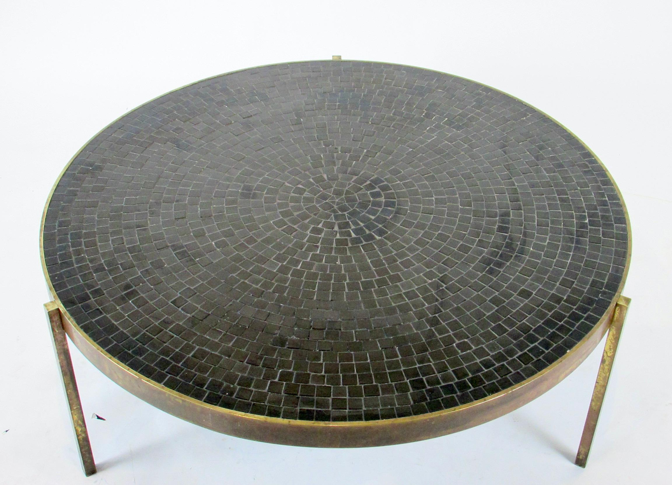Black ceramic tiles set in a concentric design set in an inch and a quarter wide bronze band. All supported on three. 75