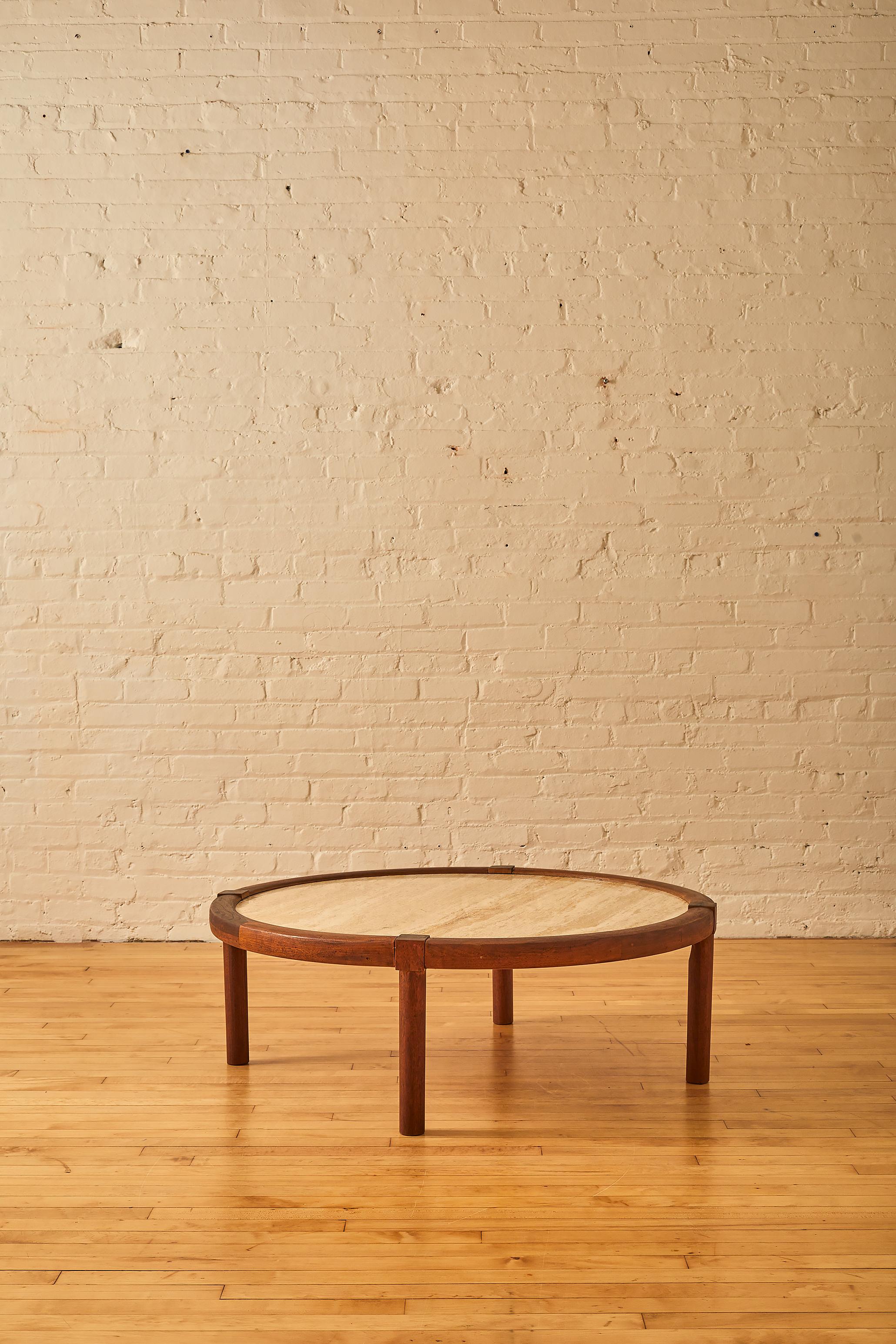 Round Travertine coffee table with walnut frame.

 