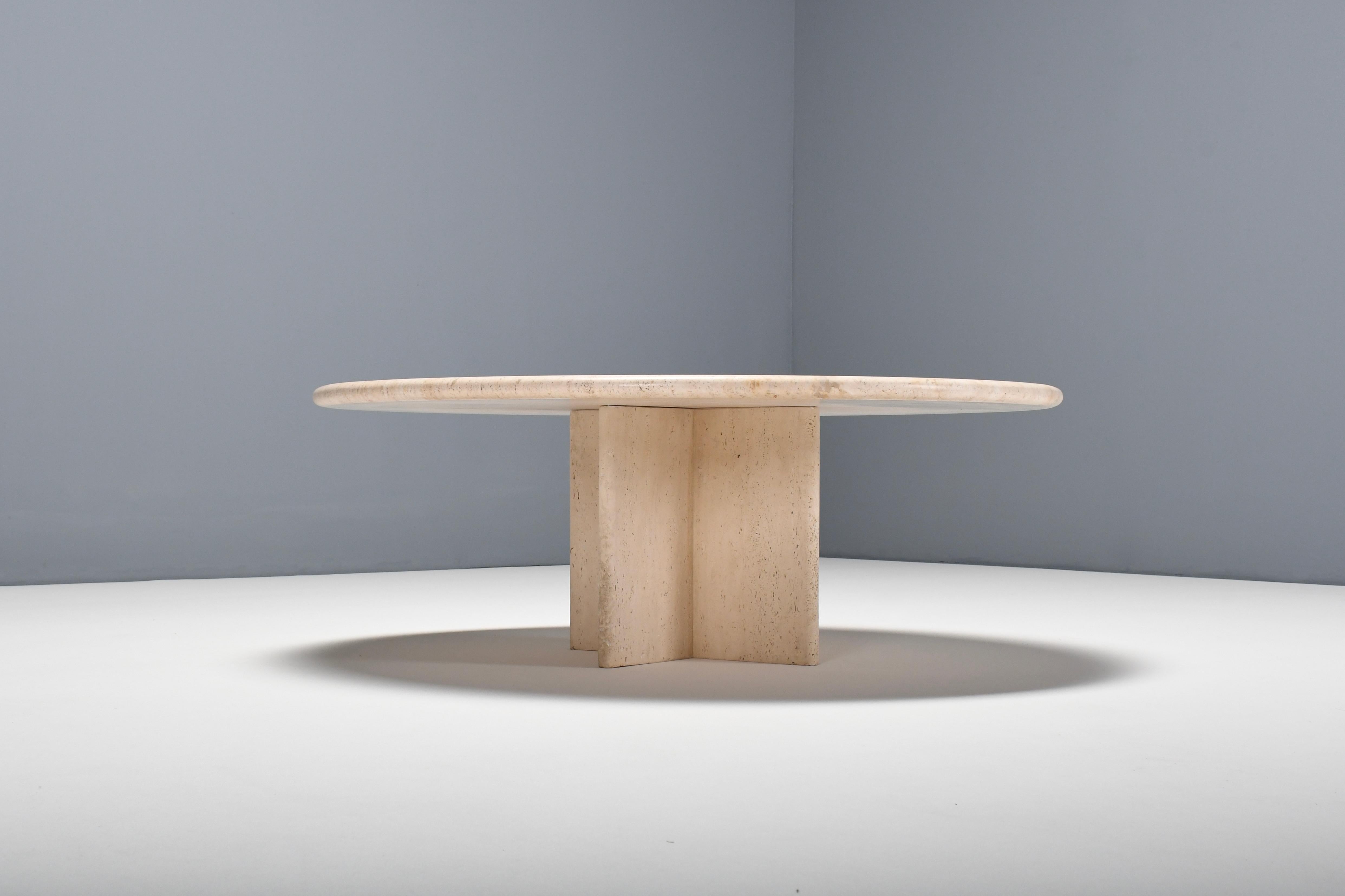 Round travertine coffee table in very good condition. 

The table has a round travertine top. 

The base is formed of four slabs of travertine, which combine into star shape. 

The travertine surface is absolutely breathtaking and makes the