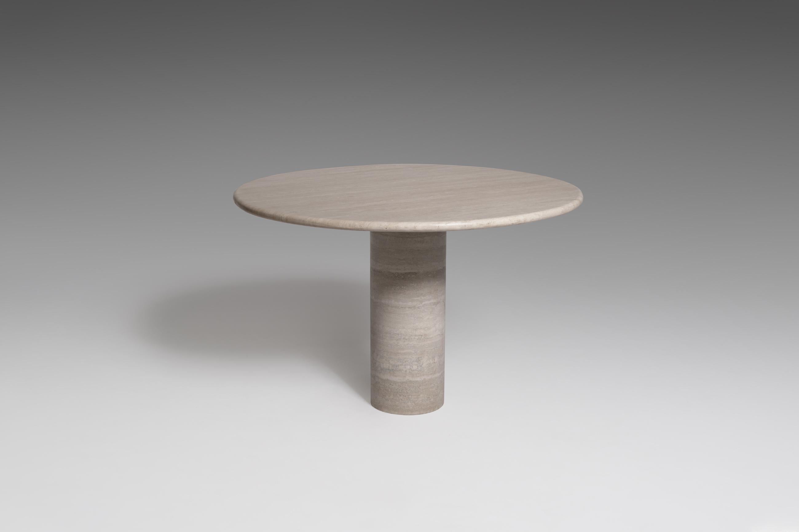 Mid-Century Modern travertine dining table, Italy 1970s. A large, thick round top rests on a solid cylinder shaped travertine base, resulting in an almost sculptural appearance. The top is provided with nicely rounded edges and has a beautiful