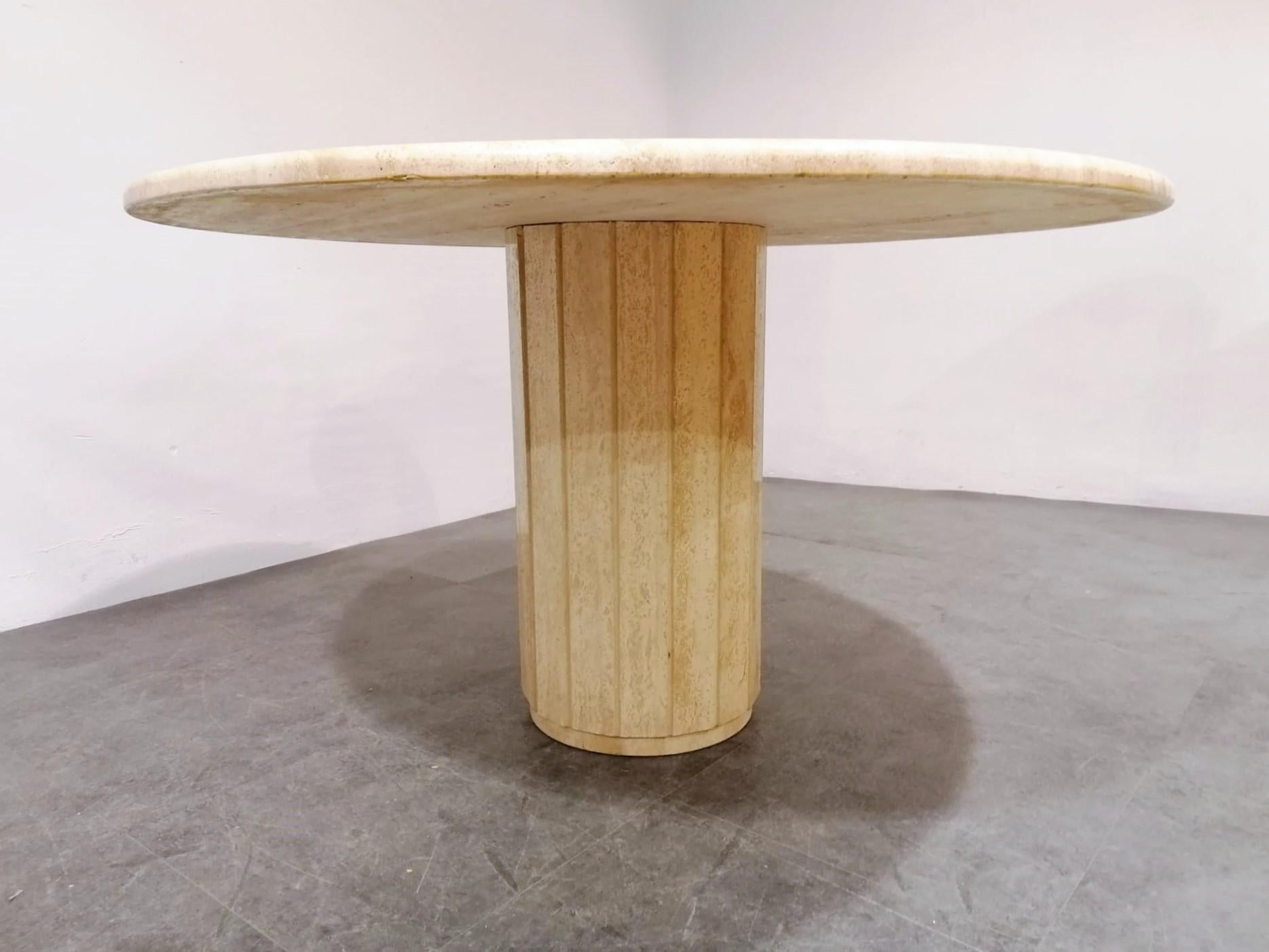 Beautiful travertine stone dining or center table.

The table has a beautiful base with travertine slats.

Good condition

1970s, Italy

Measures: Height 74cm/29.13