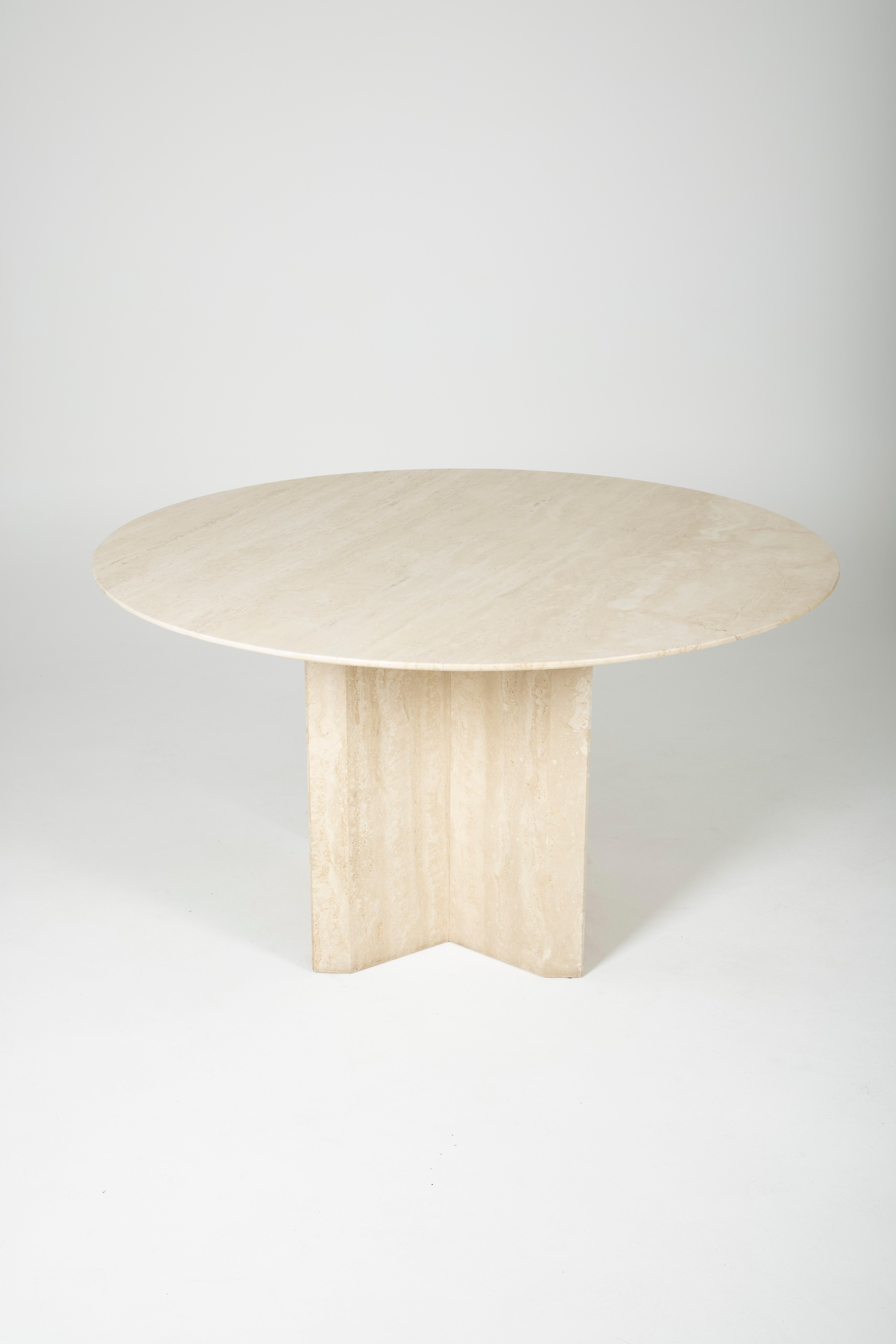Round dining room table in travertine. The top rests on two removable feet. Very good condition.