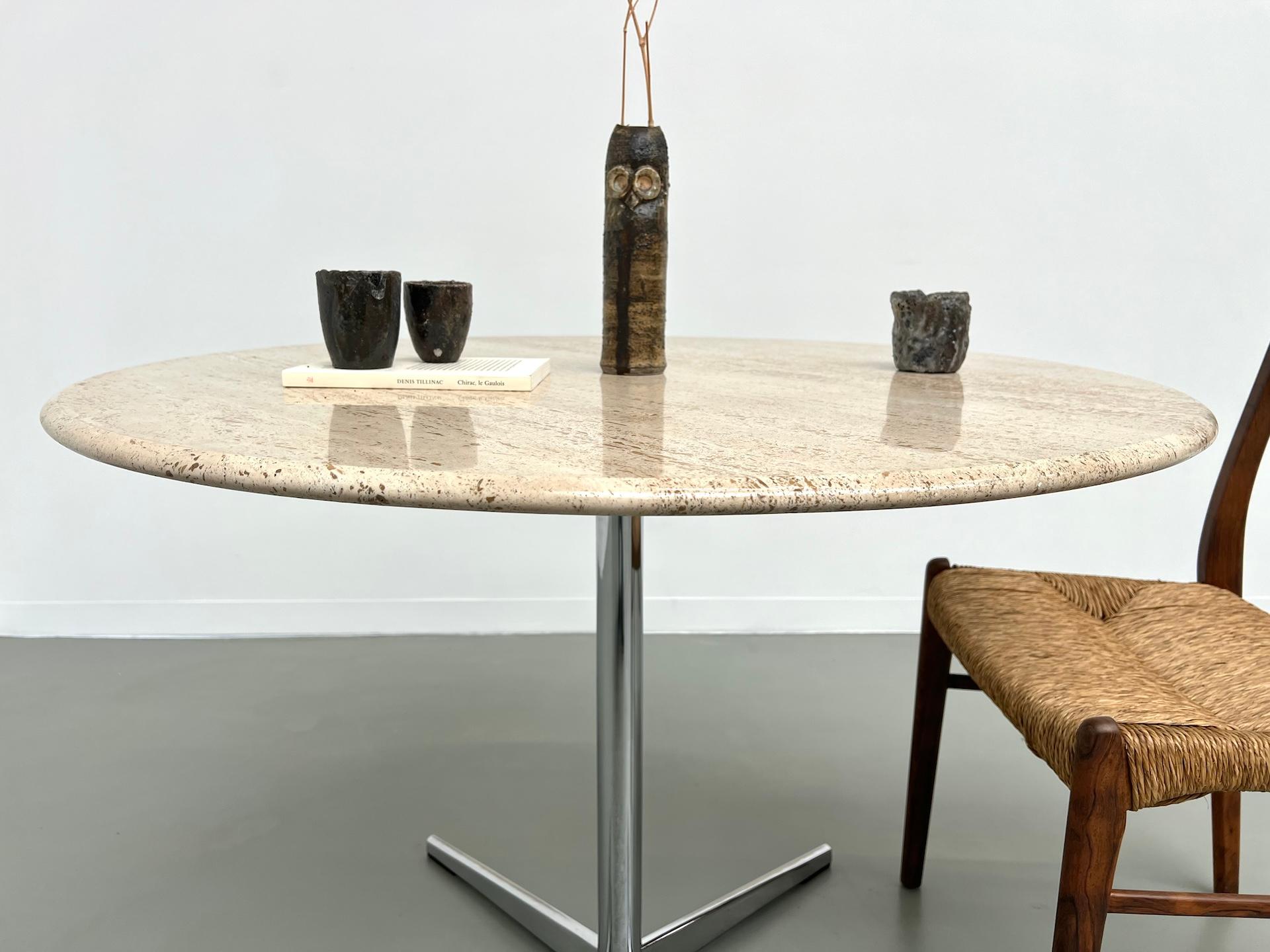 Round travertine dining table, circa 1970. 1