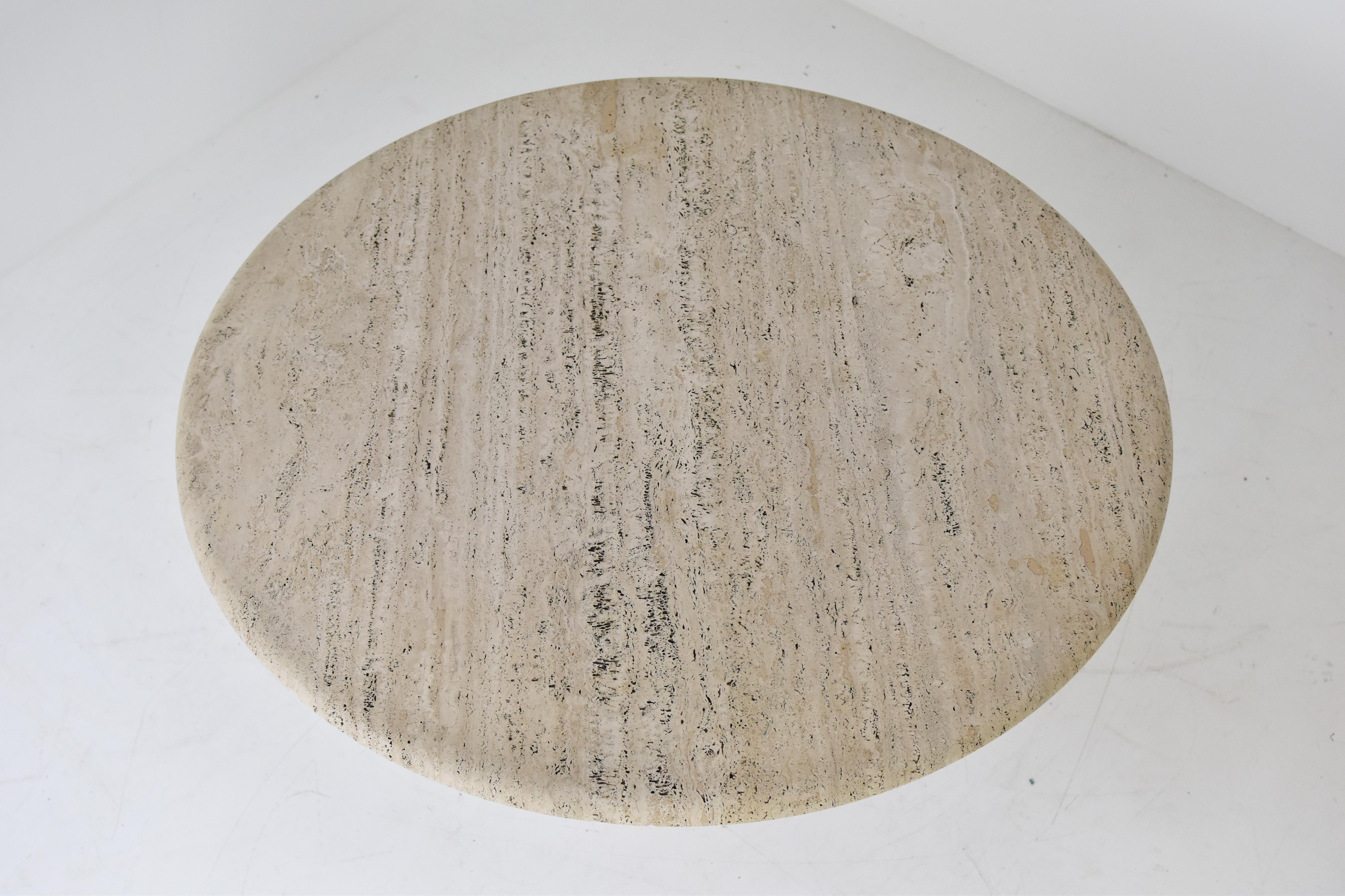 Travertine Round travertine dining table in the manner of Angelo Mangiarotti, Italy 1970’s