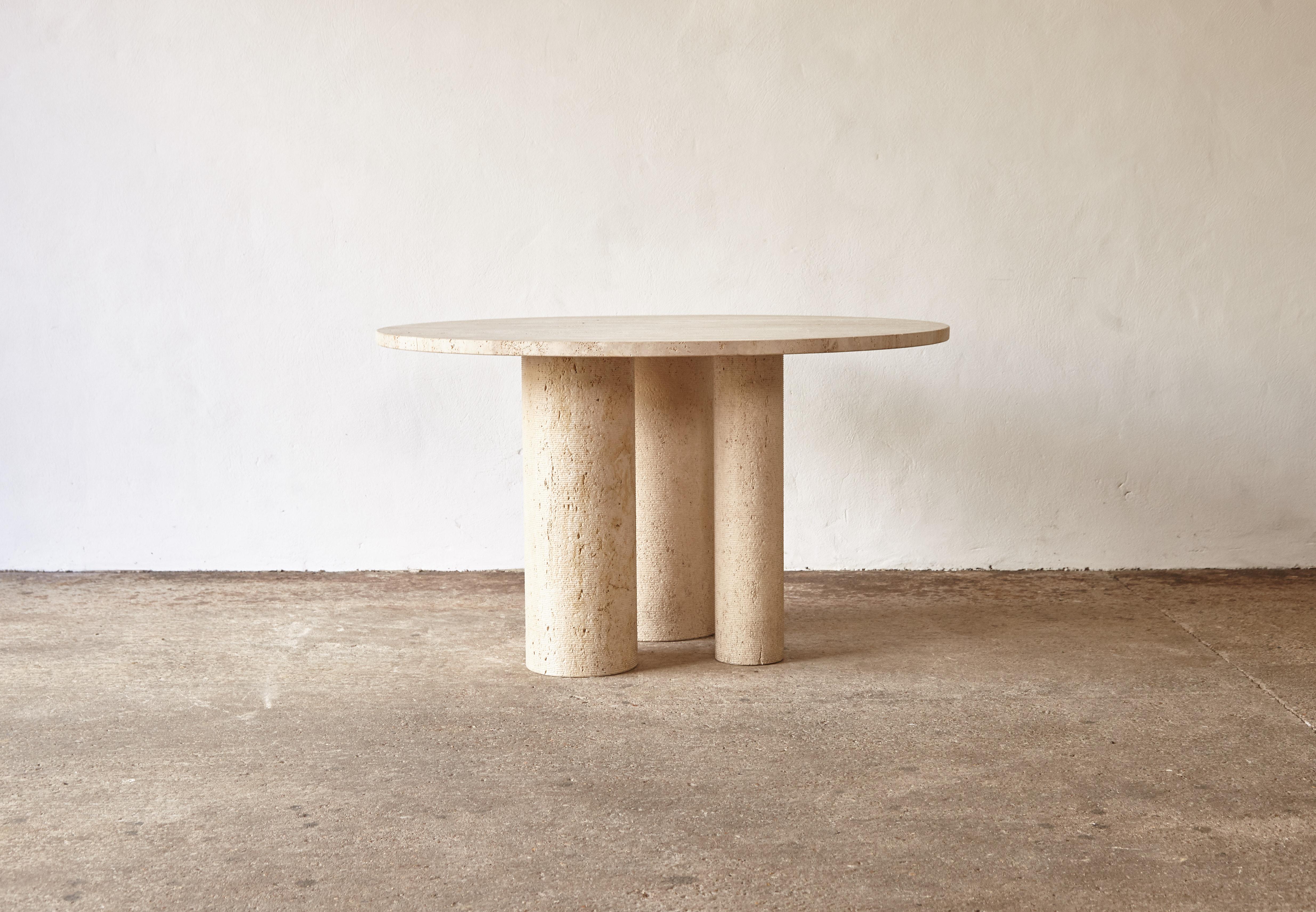A round raw travertine dining table, Spain, circa 1980s. Round tabletop resting on three cylindrical legs of varying sizes. Good vintage condition.   Fast shipping worldwide.





Please note: Prices do not include VAT. VAT may be applied depending
