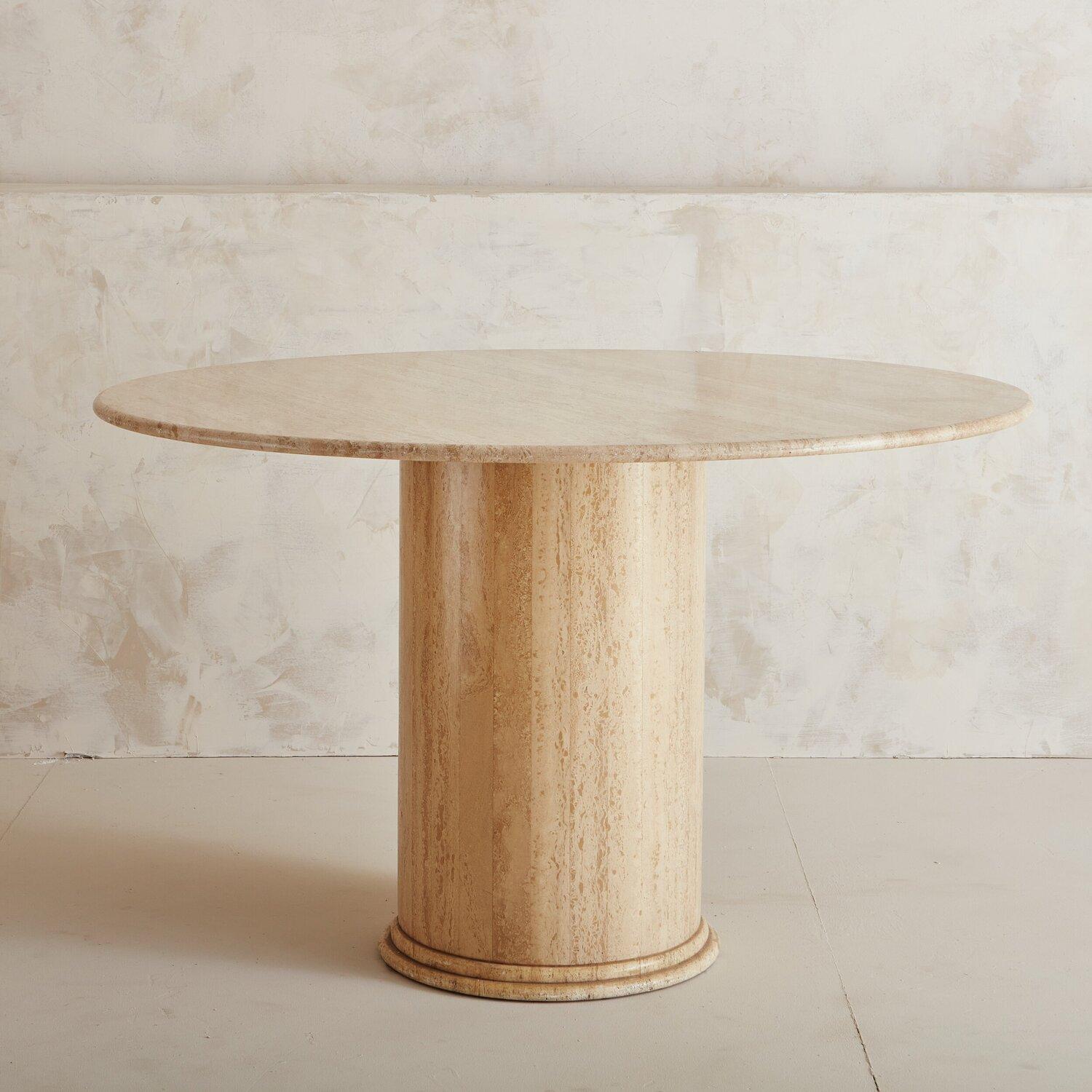A beautiful honed Travertine dining table featuring a large circular mitered base with a banded-edge detail. Sourced in Northern Spain. 

Dimensions: 31” Height x 48.75” Diameter; Top: 1” Thick; Base: 16.75” Diameter.

 