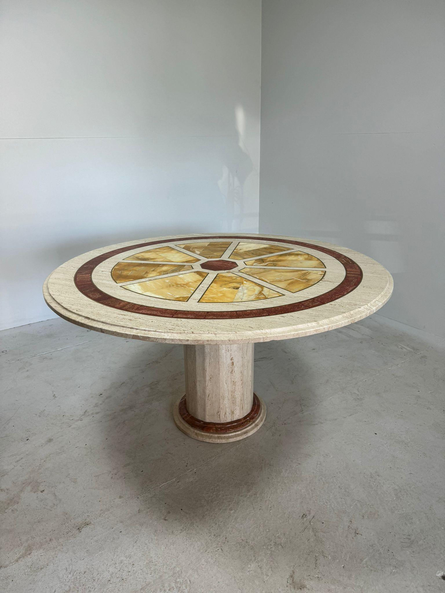 Amazing, monumental round travertine diningtable with yellow and red marble inlay, finished with brass inlay contours.

In very good condition as shown on pictures. One small pinch in the yellow surface.

Comes in 2 parts.

Video on request.

Height