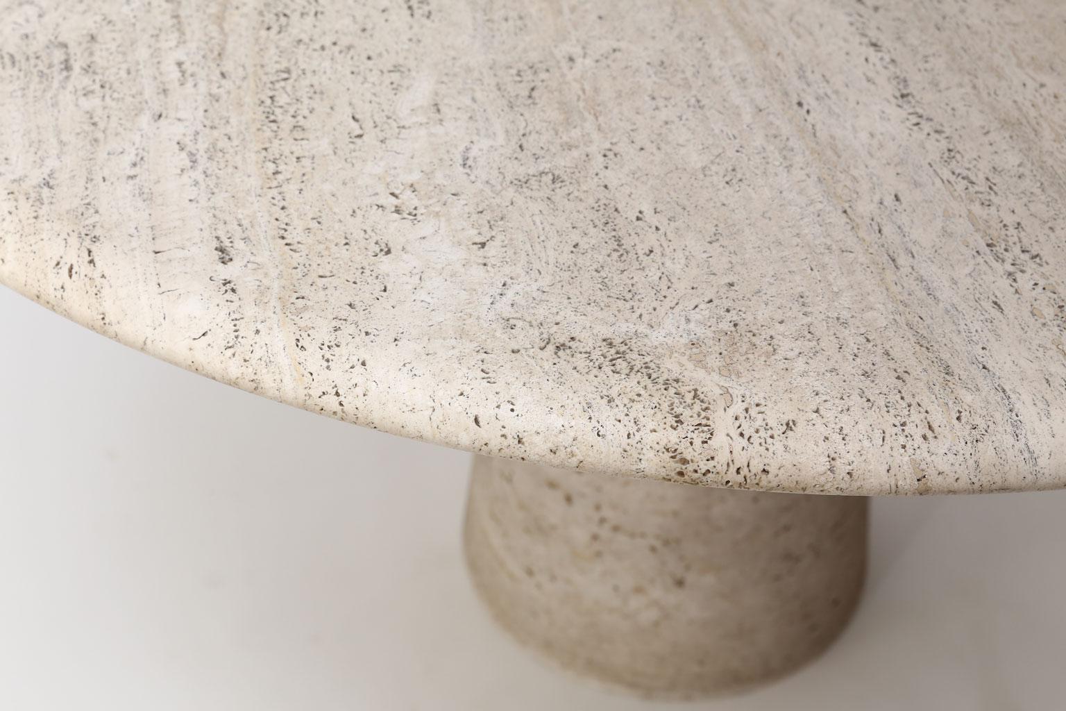 Round travertine table attributed to Angelo Mangiarotti Round travertine table attributed to Angelo Mangiarotti (circa 1970s). Round smoothed-edge 50 inch diameter top rests open a pedestal that tapers upwards from the floor. Table can easily seat