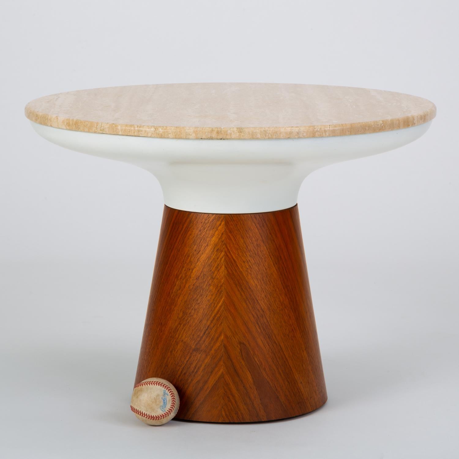 A round pedestal side table designed in 1965 by Frank Rohloff and produced in California by Brown Saltman. The color-blocked pieces has a travertine surface that sits flush with an angled frame of enameled steel. This segment fits seamlessly with